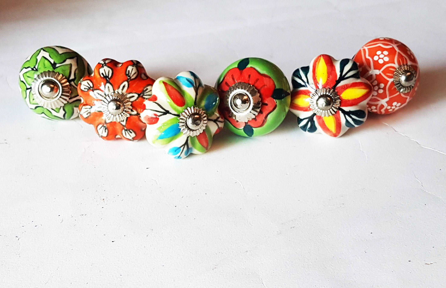 6 cabinet knobs Dolce exclusive collection. Hand painted floral ceramic art. Drawer pulls. one and one half inches in diameter