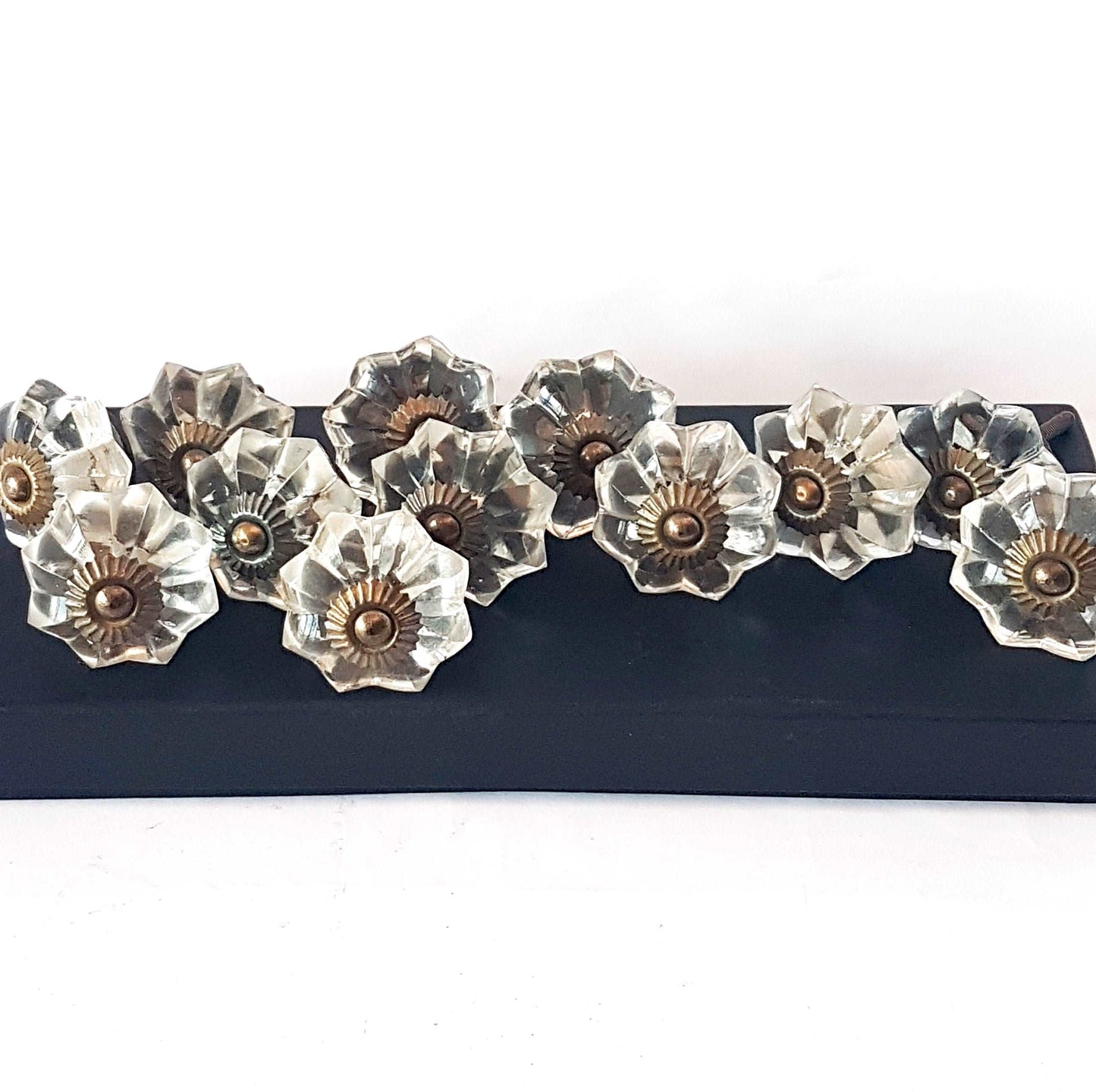 12 clear crystal cabinet knobs. Cut glass pulls in melon shape with antique look bronze fittings.Vintage design dresser & cupboard hardware.