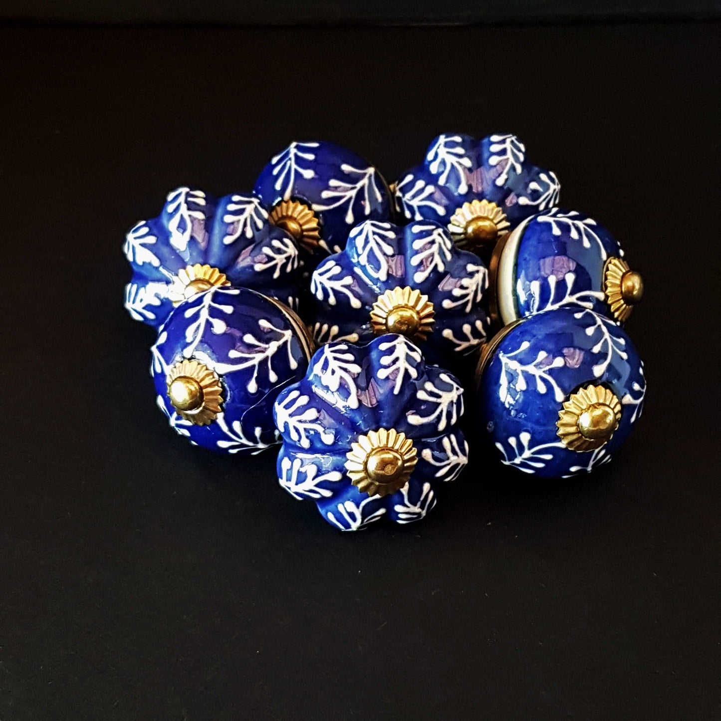 8 Delft cabinet knob drawer pulls in cobalt blue & white hand painted embossed designs. Exclusive Regal Gold 8 piece decorator collection.