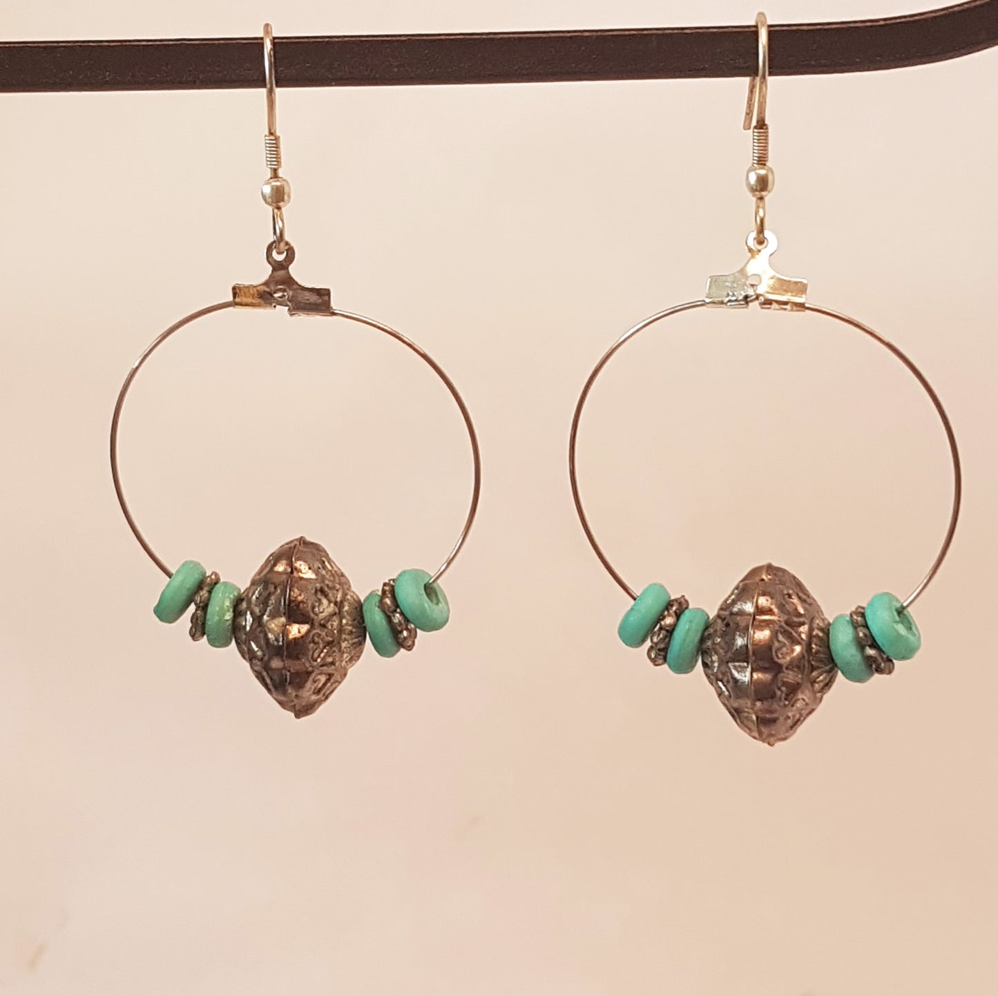 Silver hoop earrings with antique design silver & turquoise beads.