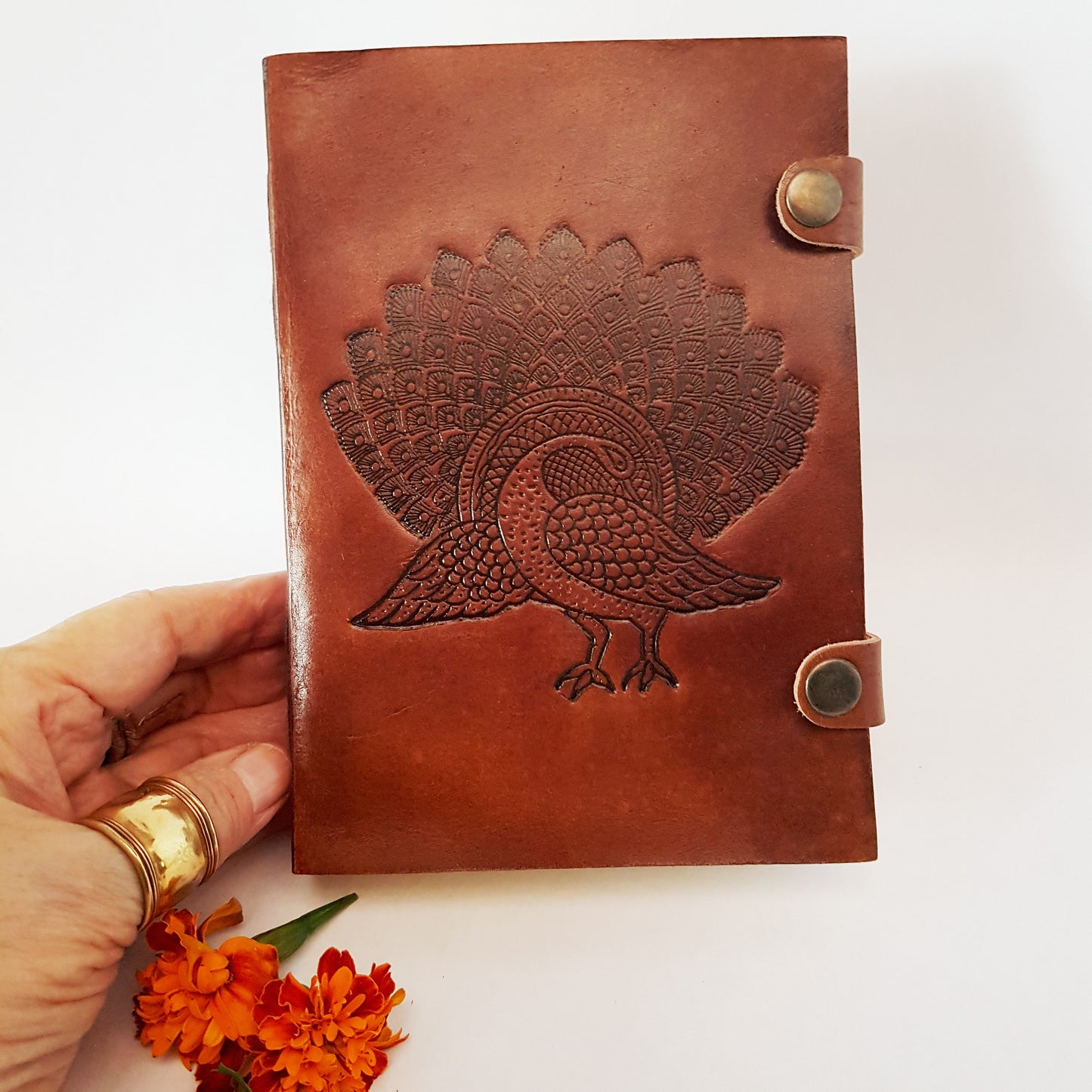 Leather bound journal with peacock design embossed cover. Bird of love motif 5 by 7 inch.