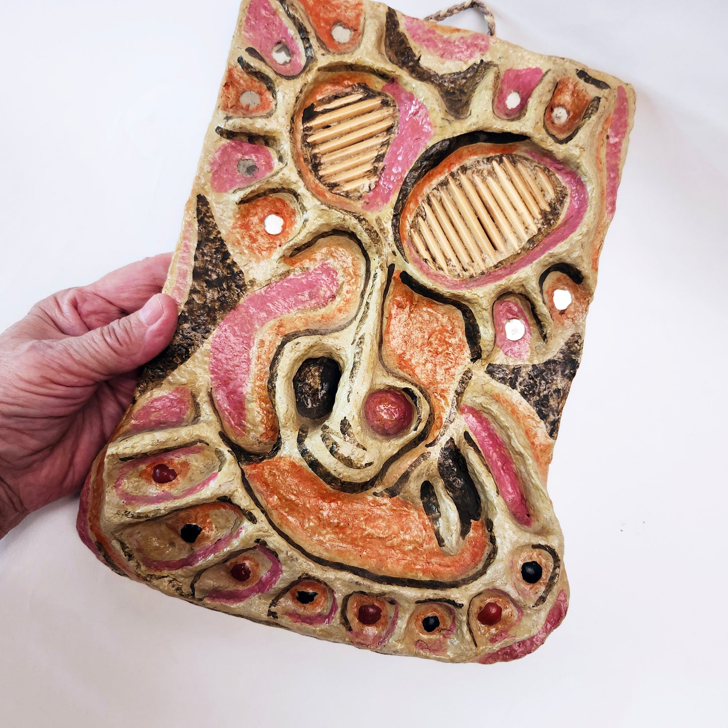 Vintage mixed media wall art mask. Pink and orange. 12 inches high.