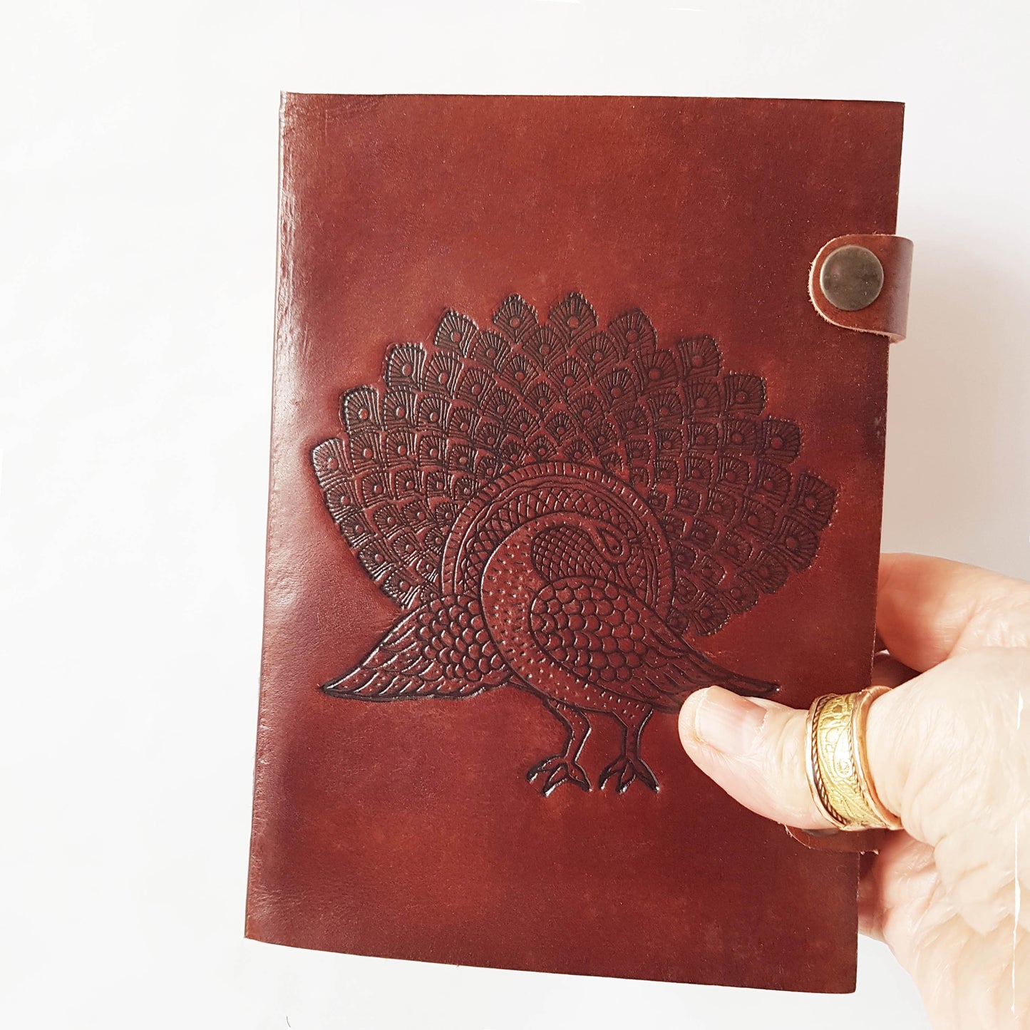 Leather bound journal with peacock design embossed cover. Bird of love motif 5 by 7 inch.