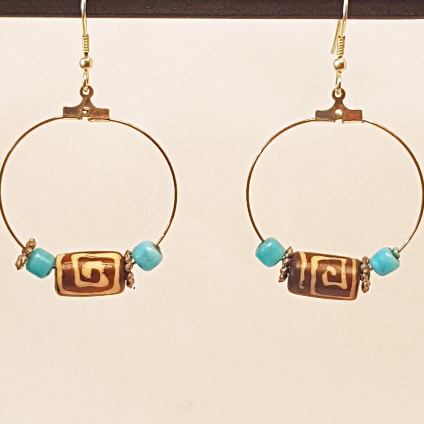 Silver hoop earrings with Dzi bead & small turquoise stones.