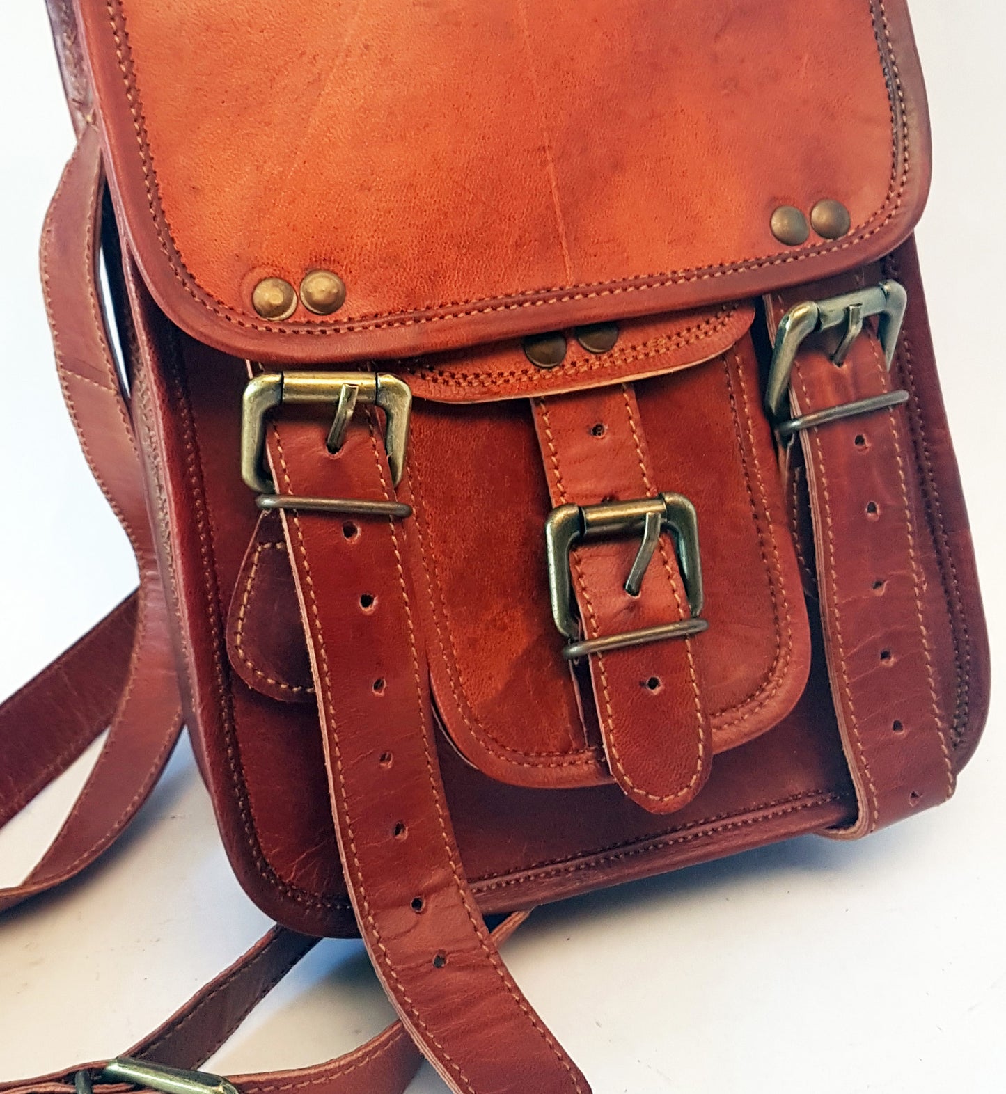 Leather messenger bag 10 by 7.5 inches with an adjustable cross body strap. Solid brass magnet buckles for easy opening & closing. Lined.