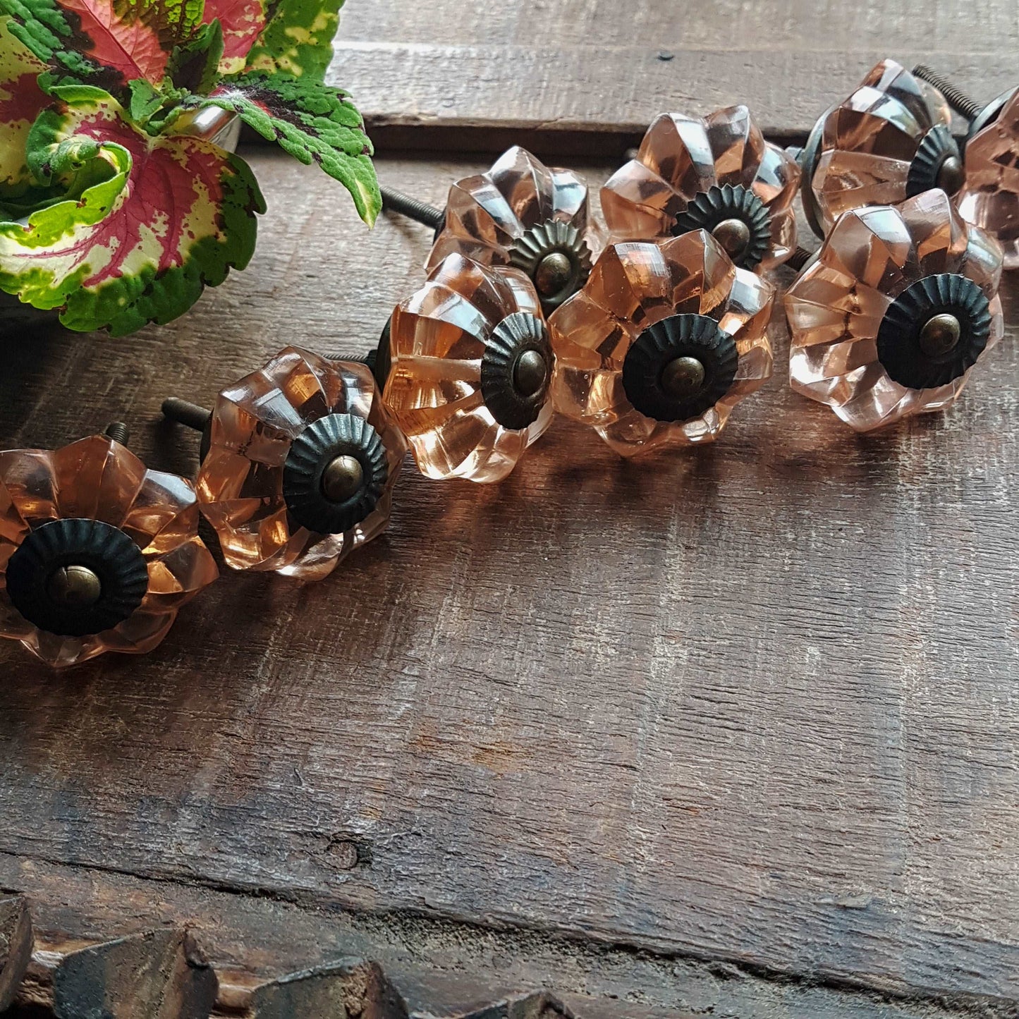 8 cranberry glass cabinet knobs with antique finish bronze centers. Transparent pink cut glass drawer pulls. Furniture hardware. 1.5 inch.