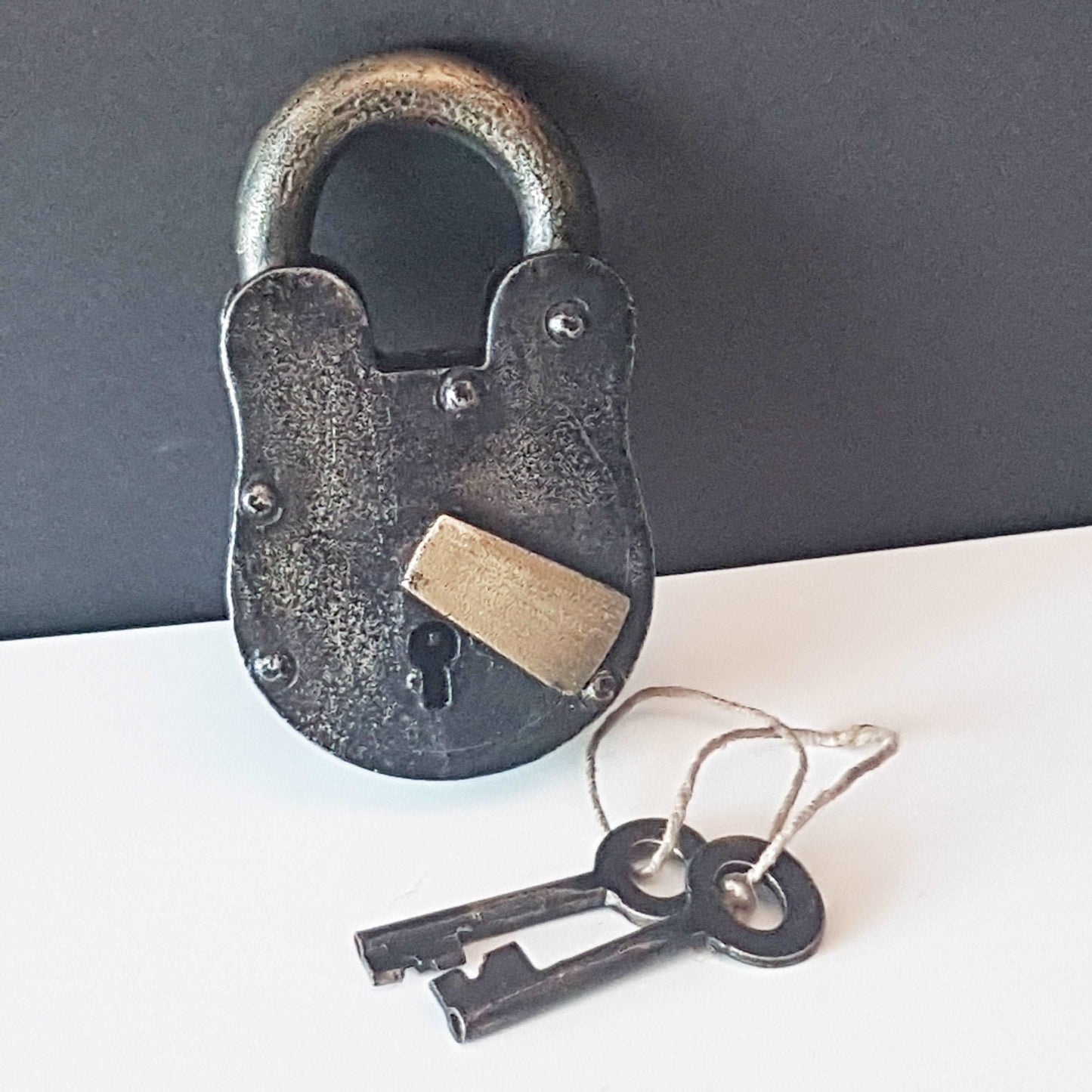 Antique metal pad lock in iron & bronze. Padlock 4 by 3 inches with 2 vintage keys. Unique old world design. Functional lock collectible.