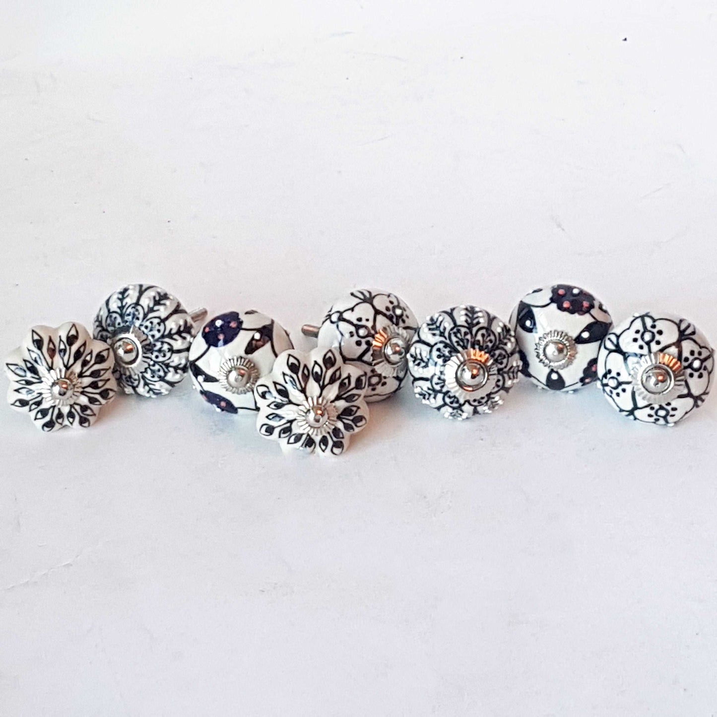 Andromeda set of 8 hand painted cabinet drawer knobs with botanical patterns in black & white. Exclusive designer collection. In stock now!