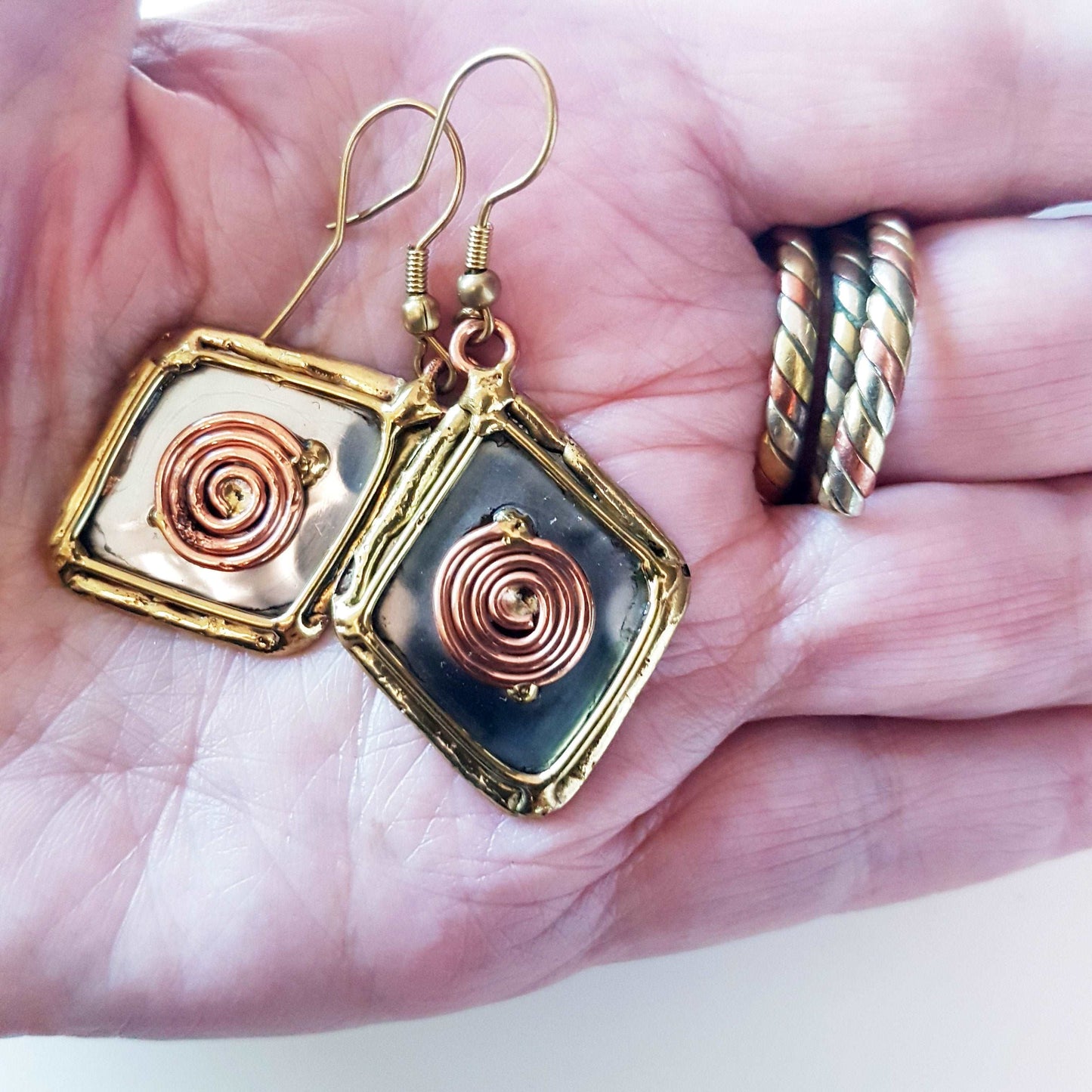 Celtic silver earrings in a diamond shape with gold and copper tone wirework detail.