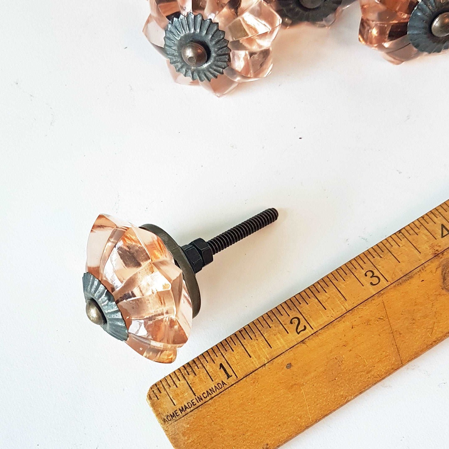8 cranberry glass cabinet knobs with antique finish bronze centers. Transparent pink cut glass drawer pulls. Furniture hardware. 1.5 inch.