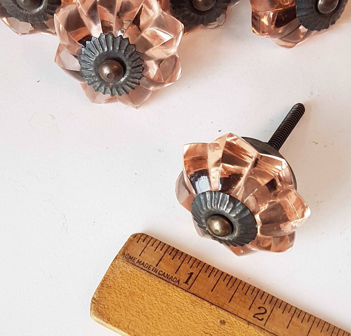 8 cranberry glass cabinet knobs with antique finish bronze centers. Transparent pink cut glass drawer pulls. Furniture hardware. 1.5 inch.