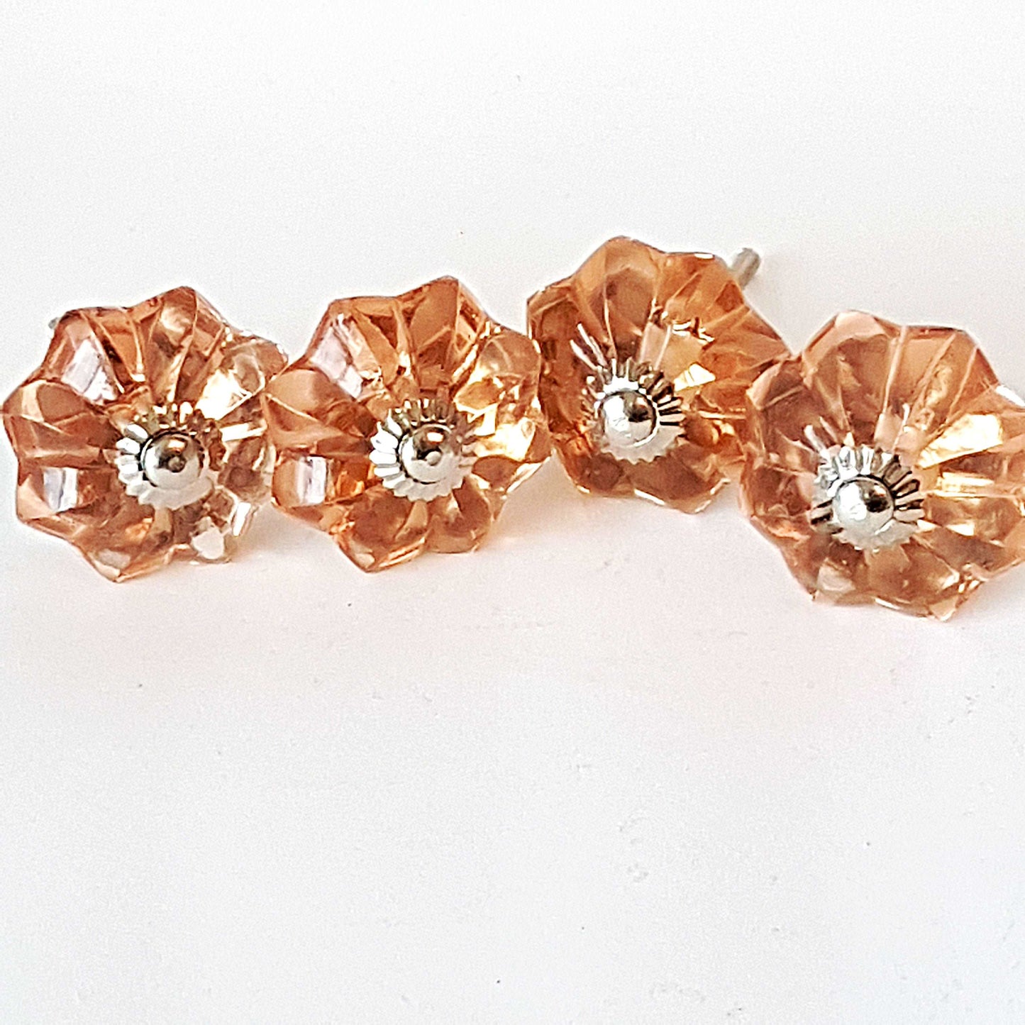 8 cranberry glass cabinet knobs with silver centers. Transparent pink cut glass drawer pulls. For kitchen cupboards, dressers, vanities.