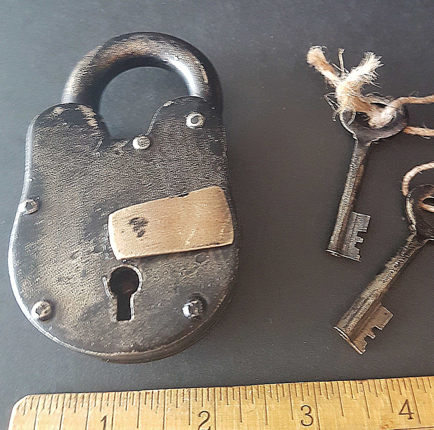 Antique finish bronze metal pad lock. Padlock 3.75 by 2 inches with 2 vintage keys. Unique old world design. Functional lock collectible.