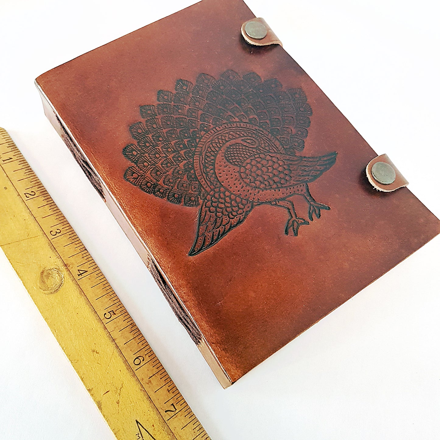 Leather bound journal with peacock design embossed cover. Bird of love motif 5 by 7 inch.