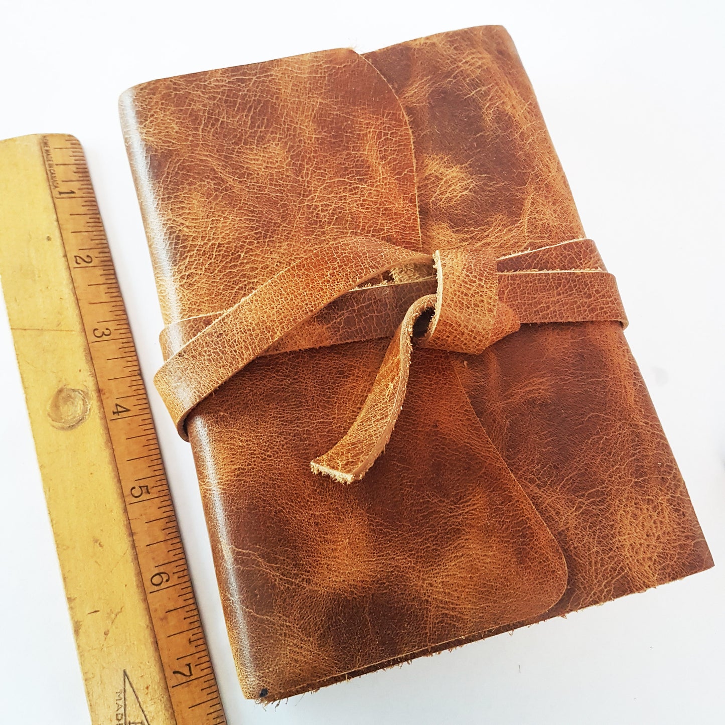Leather journal blank book with vintage design wrapping strap.