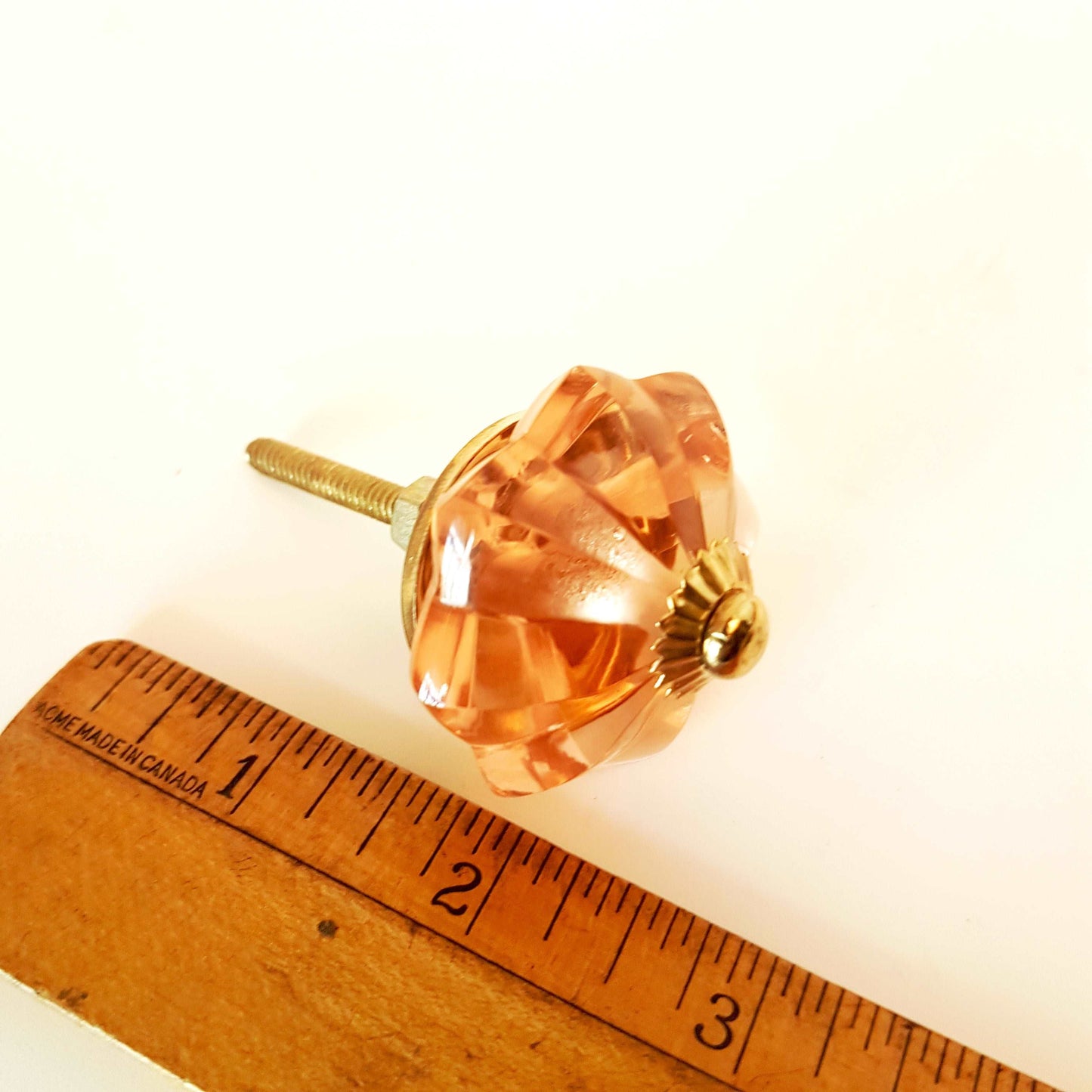 8 cranberry glass cabinet knobs with gold tone accents. Pink crystal look cut glass drawer pulls. For kitchen cupboards, dressers, vanities.