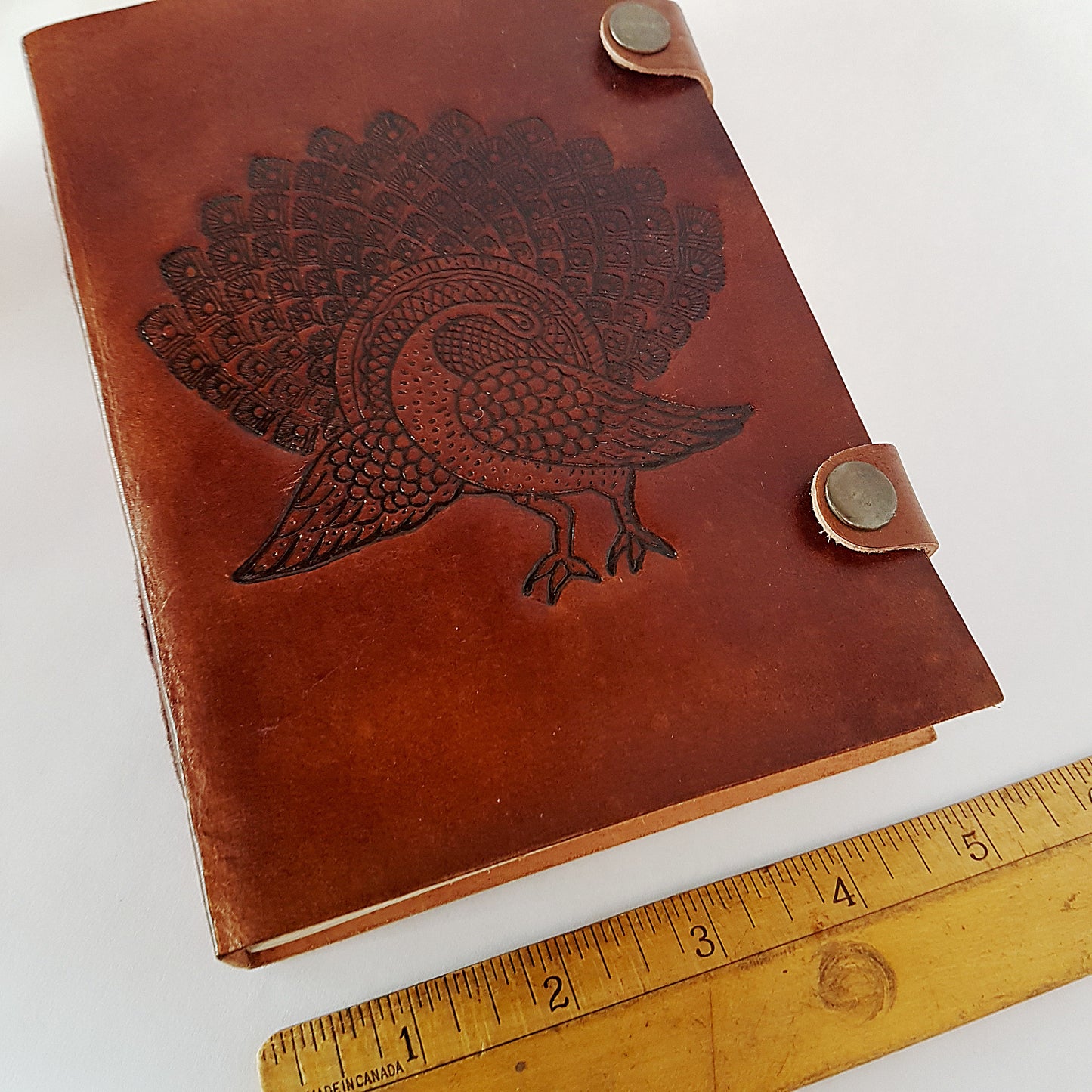 Leather bound journal with peacock design embossed cover. Bird of love motif 5 by 7 inch.