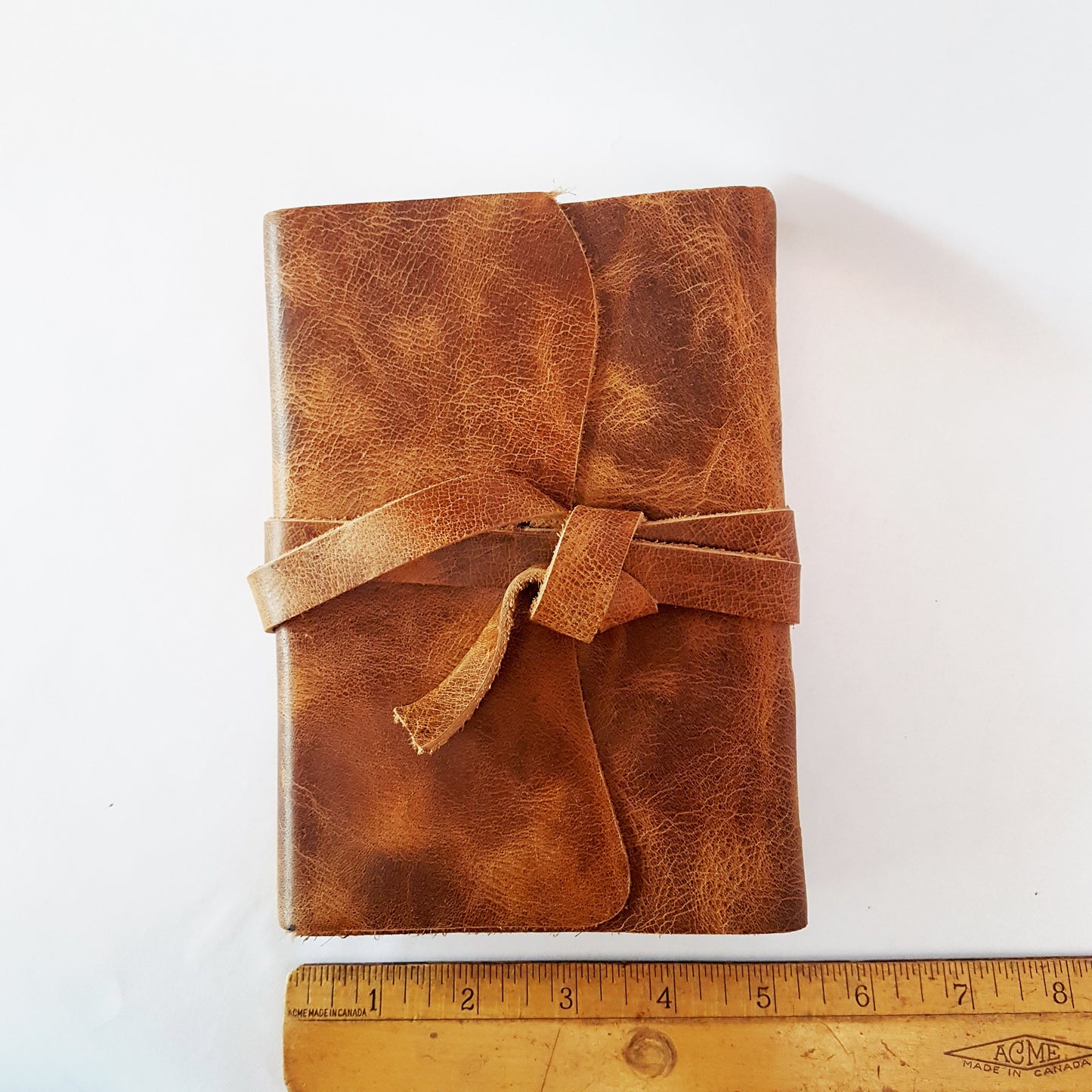 Leather journal blank book with vintage design wrapping strap.