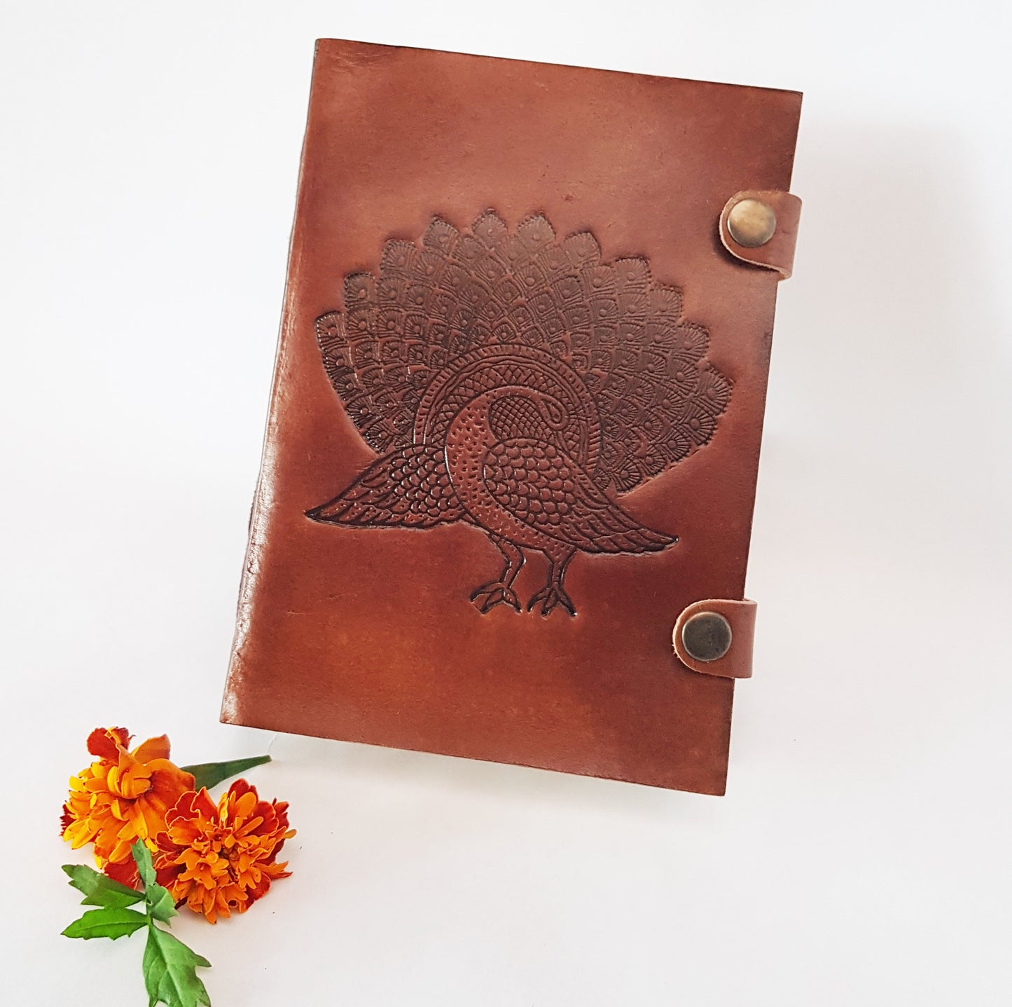 Leather bound journal with peacock design embossed cover. Bird of love motif 5 by 7 inch.