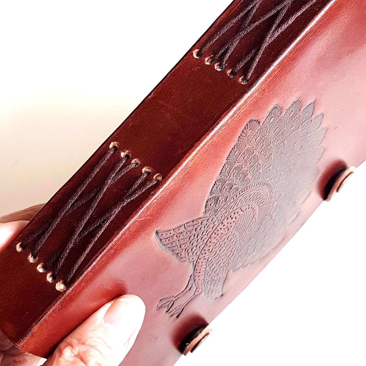 Leather bound journal with peacock design embossed cover. Bird of love motif 5 by 7 inch.