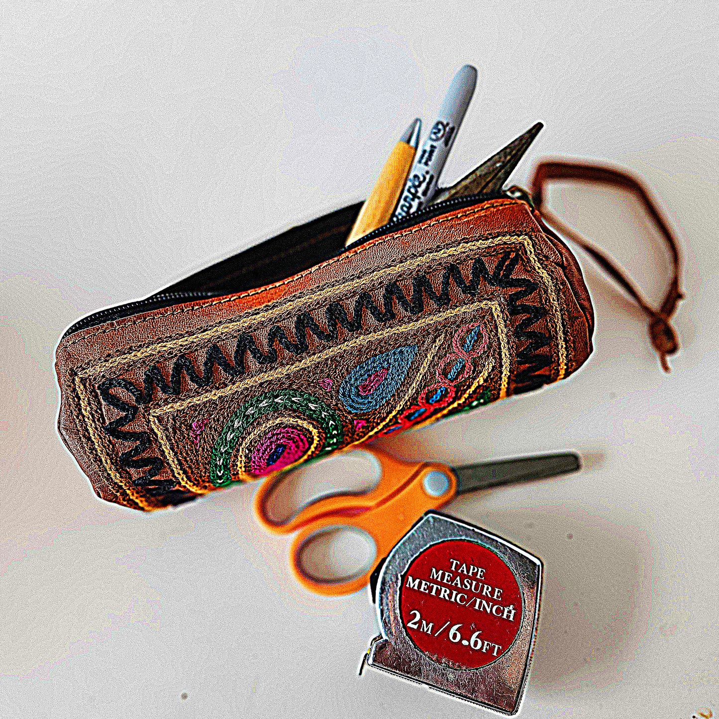 Leather Tube Pouch with a Colorful Hand Embroidered Boho Hippie design.