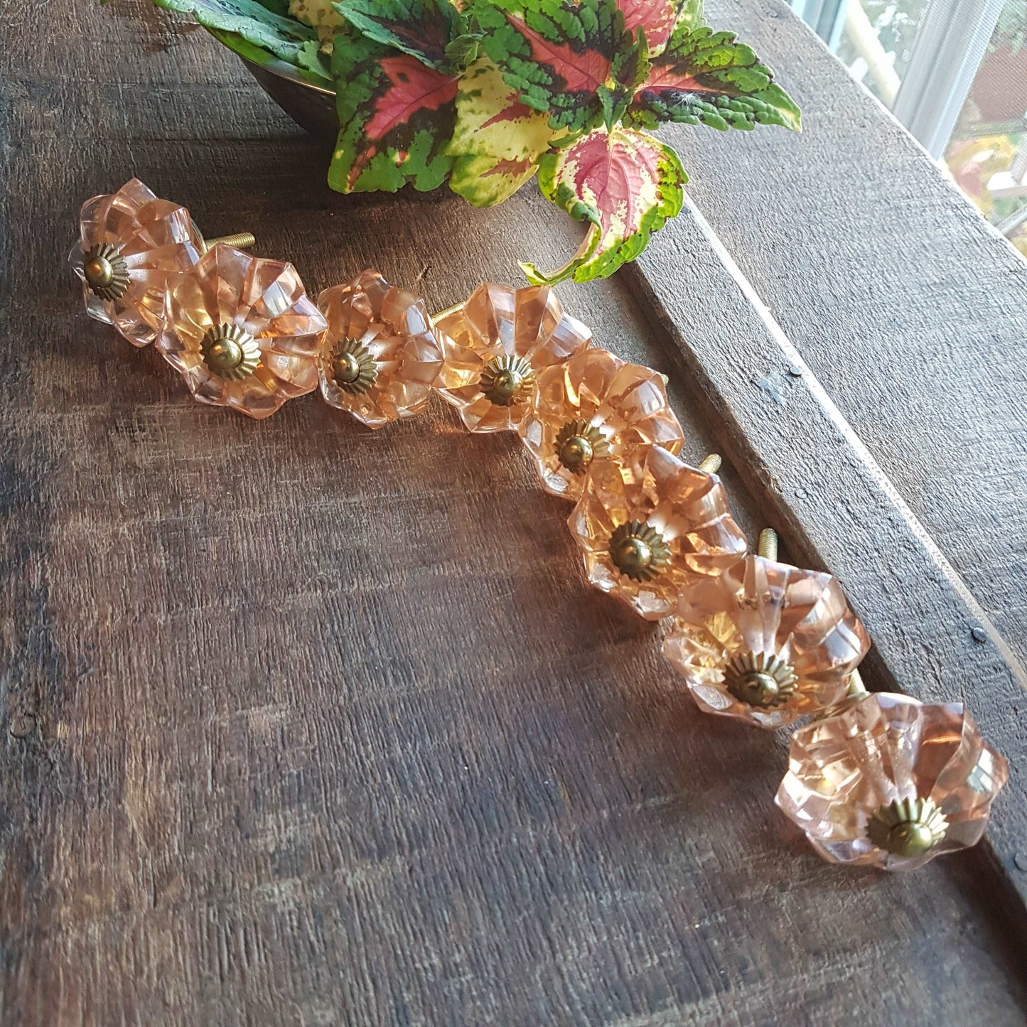8 cranberry glass cabinet knobs with gold tone accents. Pink crystal look cut glass drawer pulls. For kitchen cupboards, dressers, vanities.