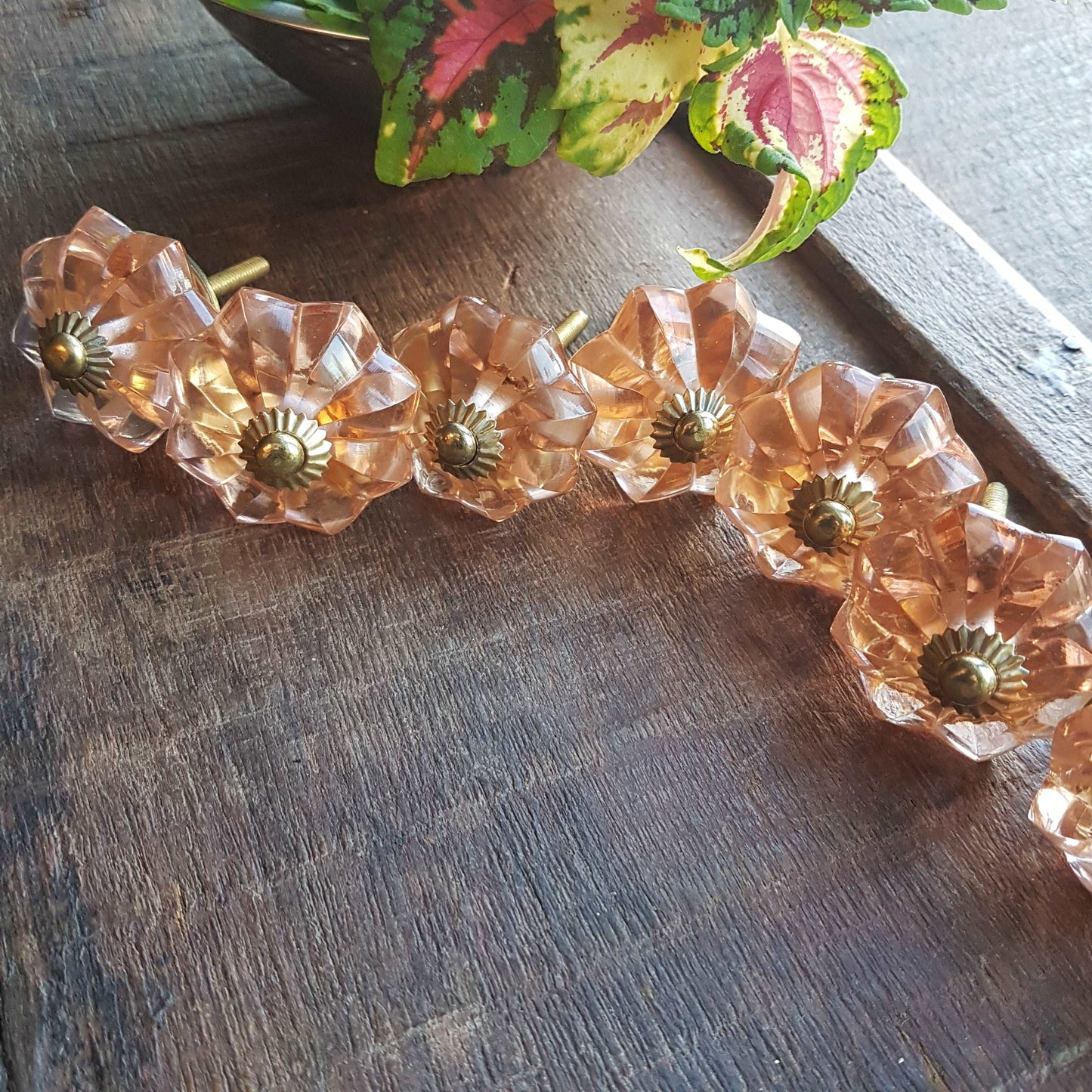 8 cranberry glass cabinet knobs with gold tone accents. Pink crystal look cut glass drawer pulls. For kitchen cupboards, dressers, vanities.
