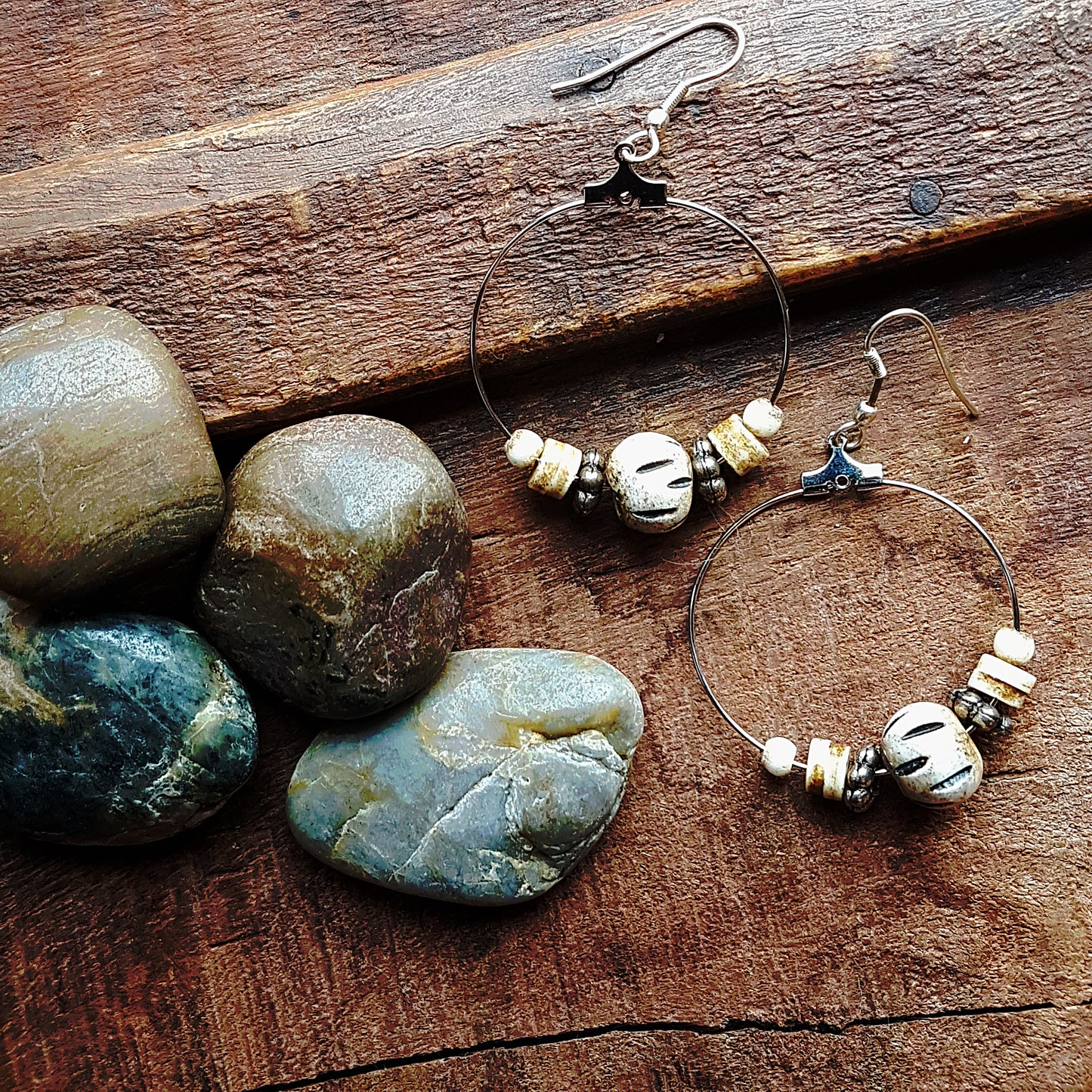 Silver hoop earrings with silver & carved bone beads. 2.5 inches hang length.