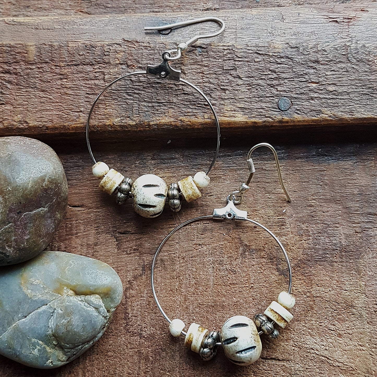 Silver hoop earrings with silver & carved bone beads. 2.5 inches hang length.