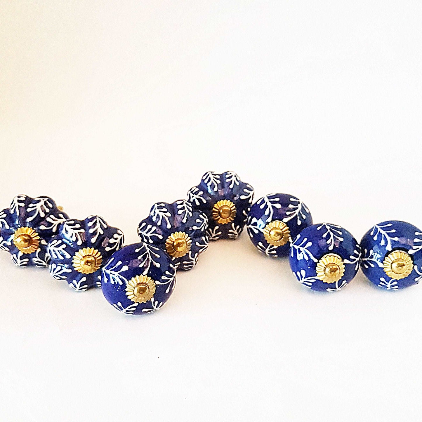 8 Delft cabinet knob drawer pulls in cobalt blue & white hand painted embossed designs. Exclusive Regal Gold 8 piece decorator collection. - Vintage India Ca