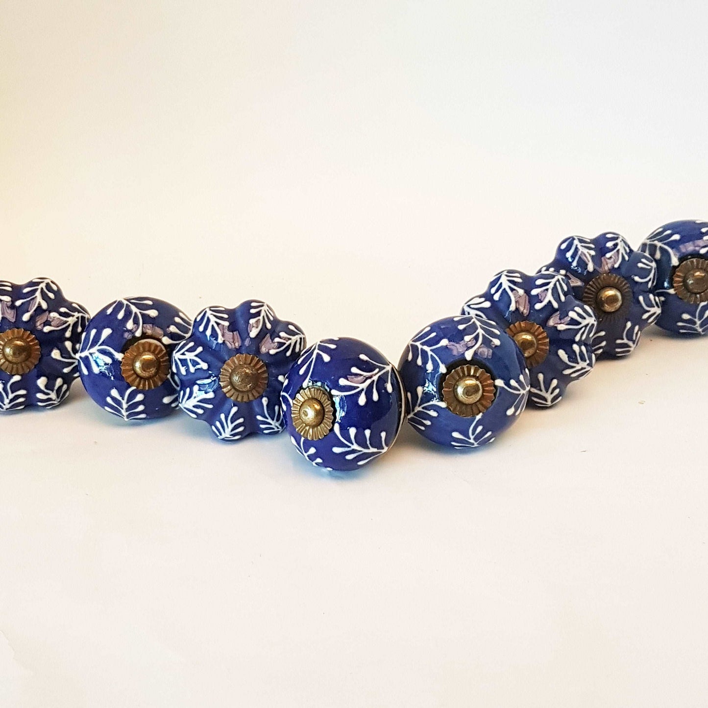 8 piece set of hand painted cabinet knob drawer pulls. 8 Delft cobalt blue & white embosssed knobs. Antique copper finish hardware fittings. - Vintage India Ca