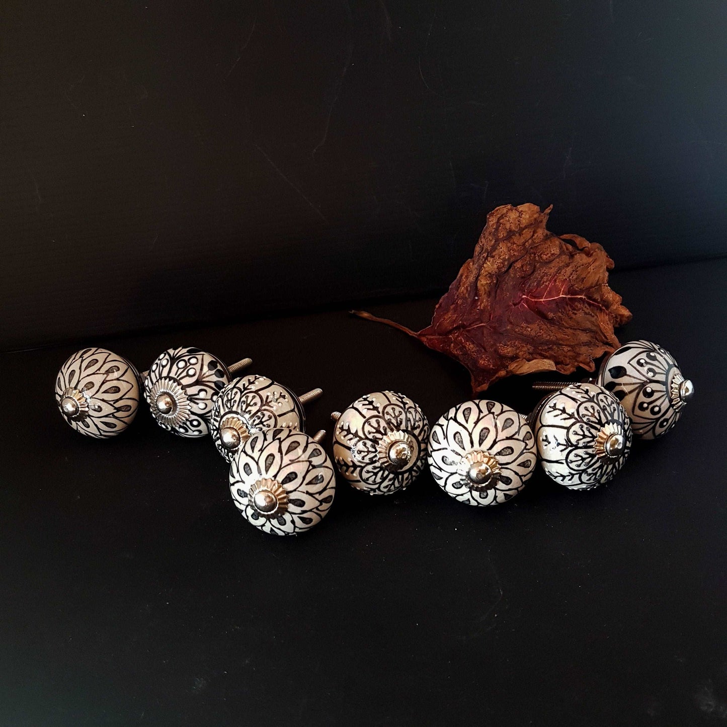 8 cabinet knob-drawer pulls in black, slate grey and cream. Elegance hand painted floral designs with silver hardware.1.5 inch in diameter. - Vintage India Ca