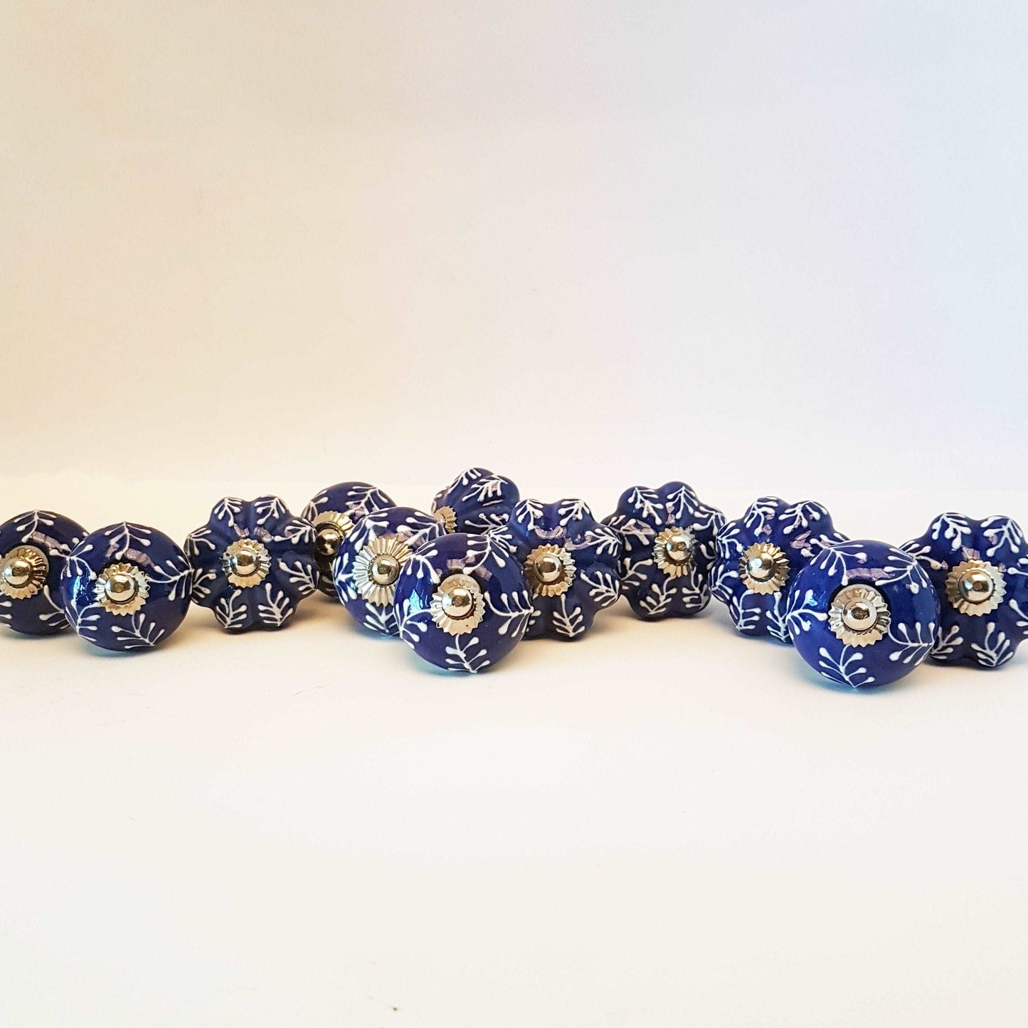 12 piece cabinet knob set. Delft cobalt blue and white drawer pulls. Each knob pull is hand painted and embossed in a botanical fern design. - Vintage India Ca