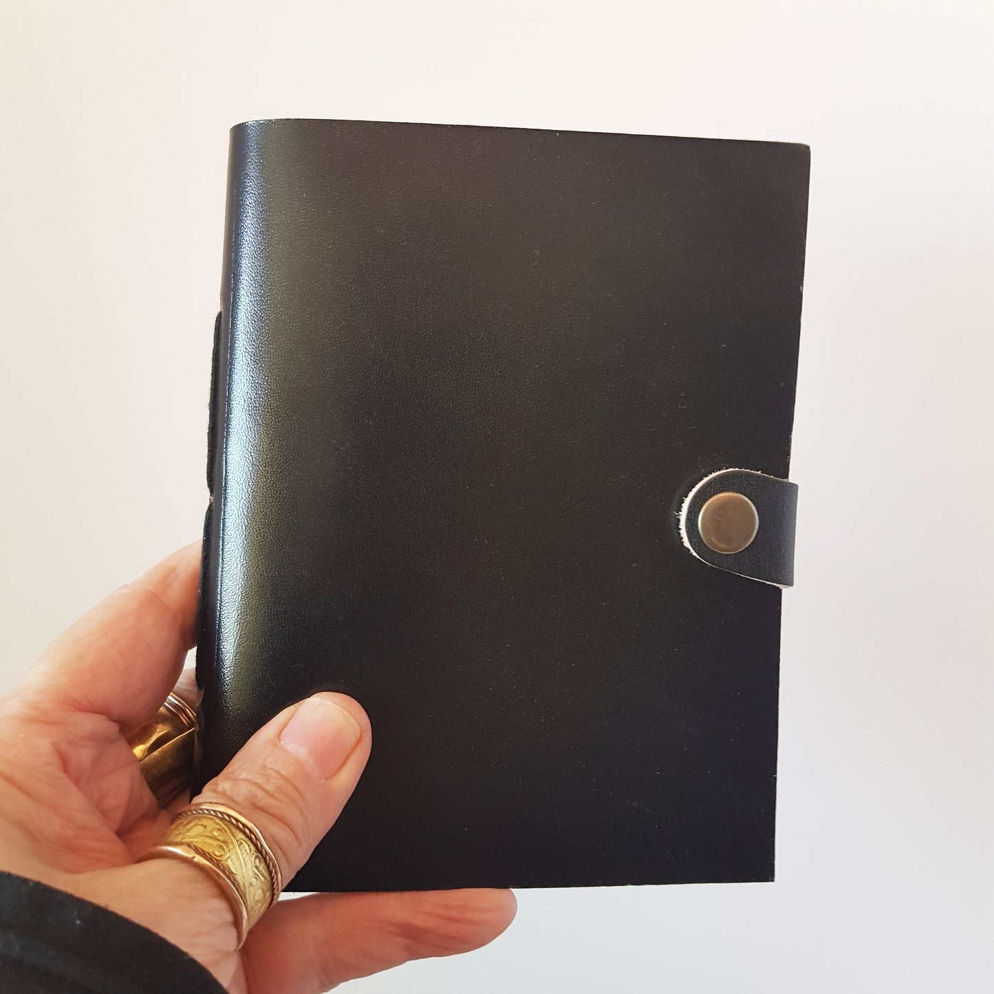 Leather bound lined journal with handmade artisan paper pages. Compact size 4.5 by 6 inches. Black, brown, red, turquoise, purple & blue.