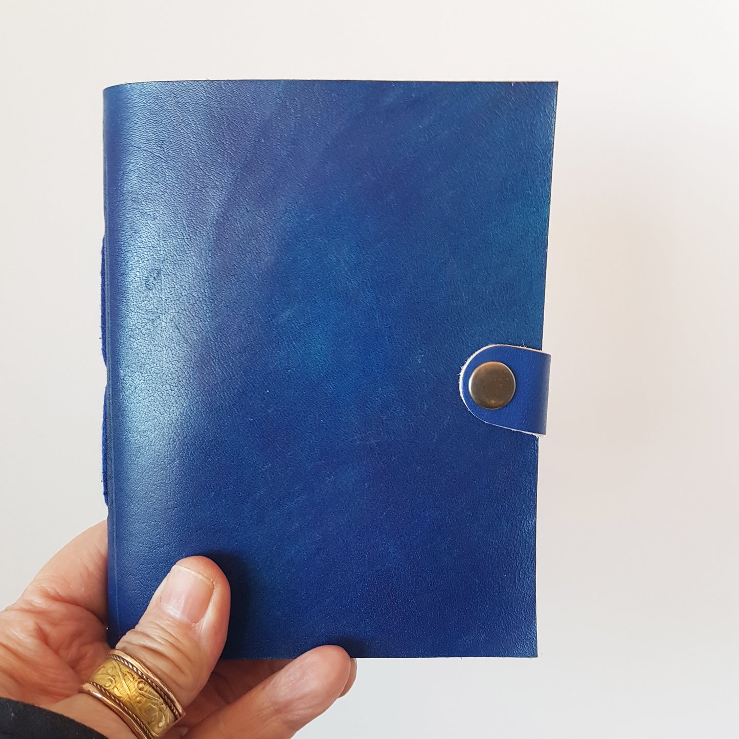 Leather bound lined journal with handmade artisan paper pages. Compact size 4.5 by 6 inches. Black, brown, red, turquoise, purple & blue.
