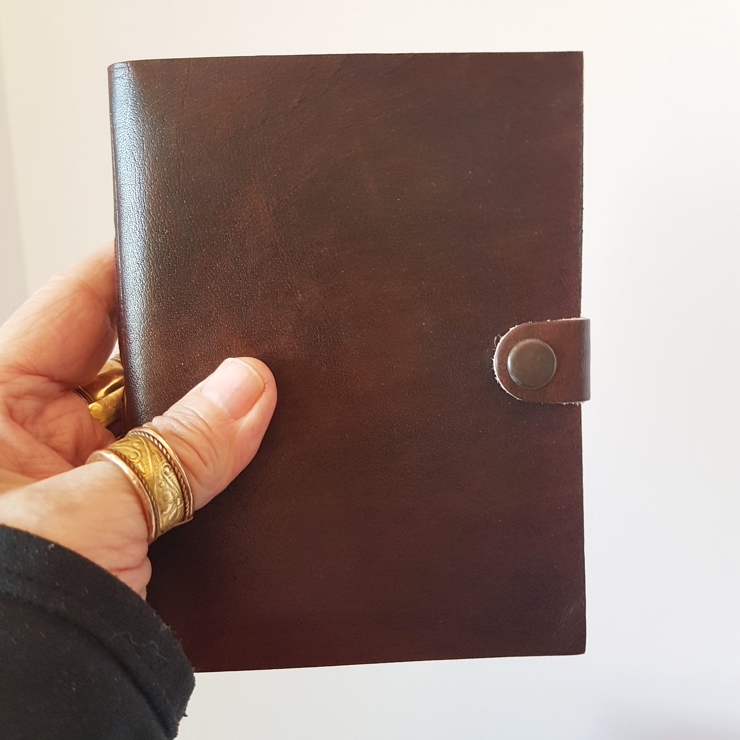 Leather bound lined journal with handmade artisan paper pages. Compact size 4.5 by 6 inches. Black, brown, red, turquoise, purple & blue.