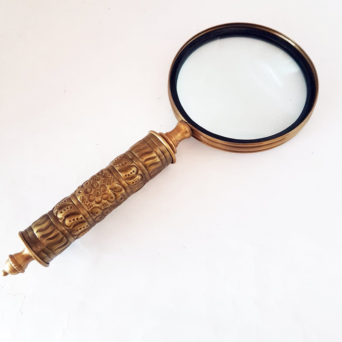 Loupe de style vintage avec une poignée en laiton repoussé d'aspect médiéval. Charme du vieux monde. Lisez facilement les petits caractères sur les étiquettes des aliments et des médicaments.