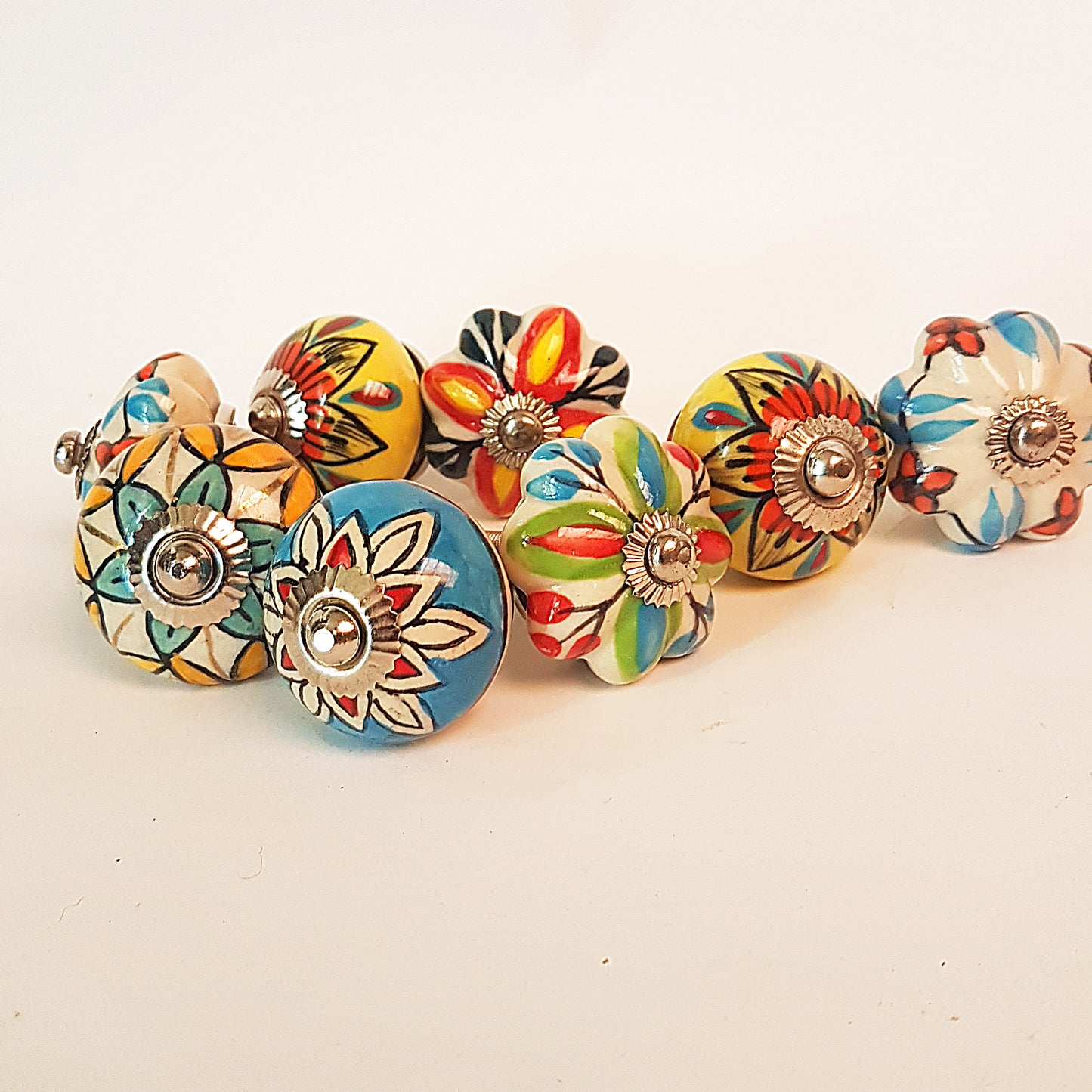 Secret Garden collection of 8 hand painted designer cupboard & drawer knobs in colorful floral patterns. Standard 1.5 inch diameter size.
