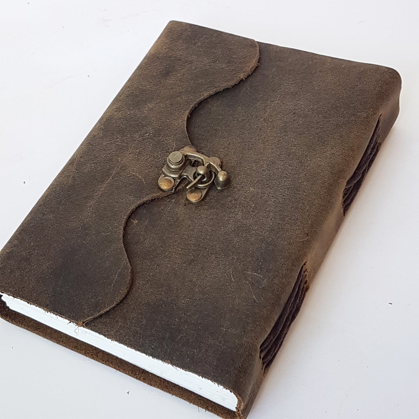 Leather bound suede diary rustic brown journal. Medieval style grimoire with bronze lock. Measures 5 by 7 inches with handmade paper pages.