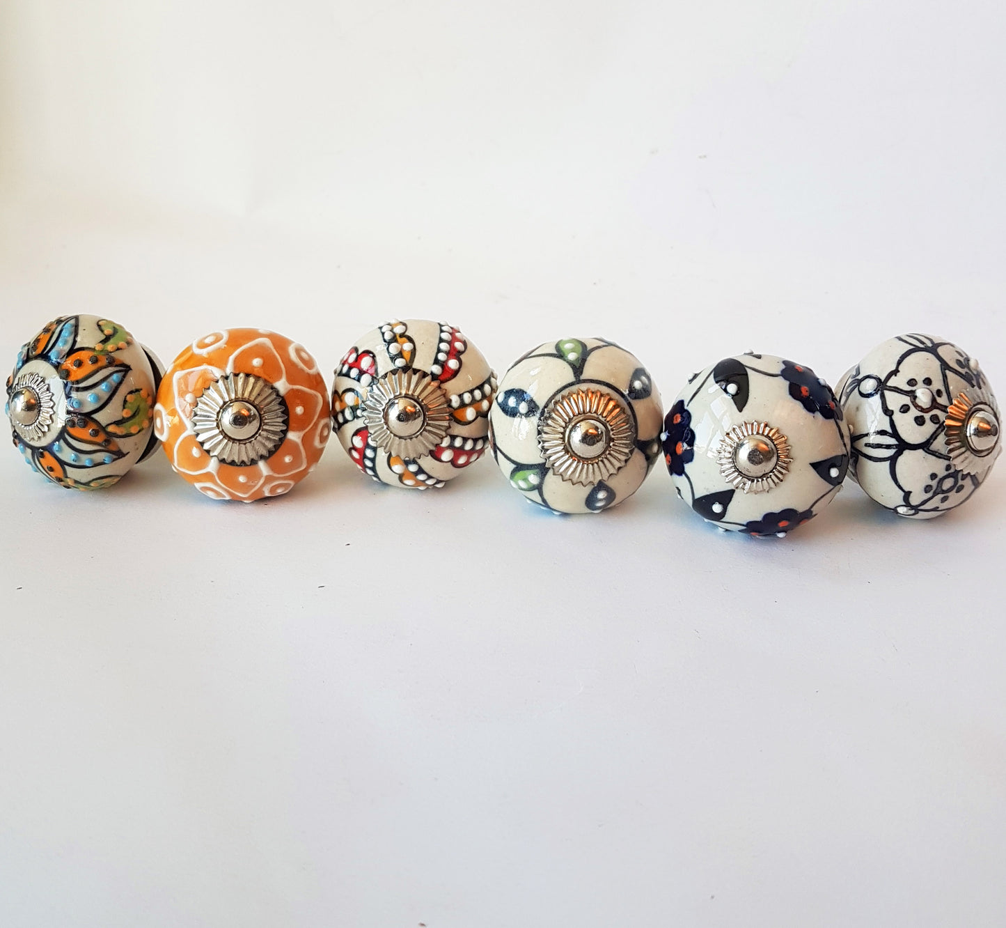 Florentine set of 6 Embossed hand painted knobs in exclusive designs. Standard 1.5 inch size.