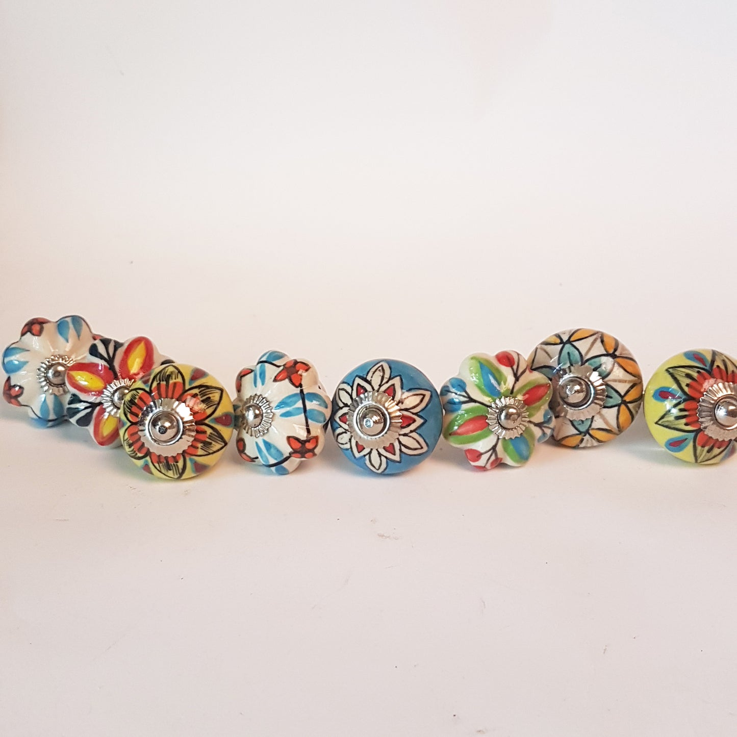 Secret Garden collection of 8 hand painted designer cupboard & drawer knobs in colorful floral patterns. Standard 1.5 inch diameter size.