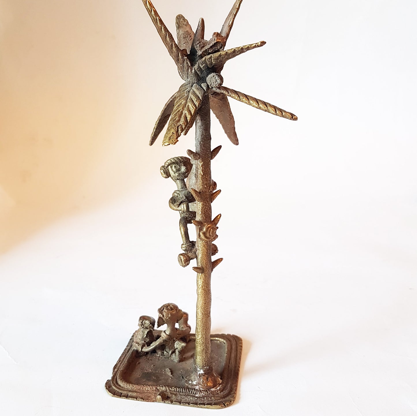 Vintage bronze monkey art sculpture. Monkey picking coconuts from tree. Animal metal collectable. India tribal art statue. 8 by 3 inches..
