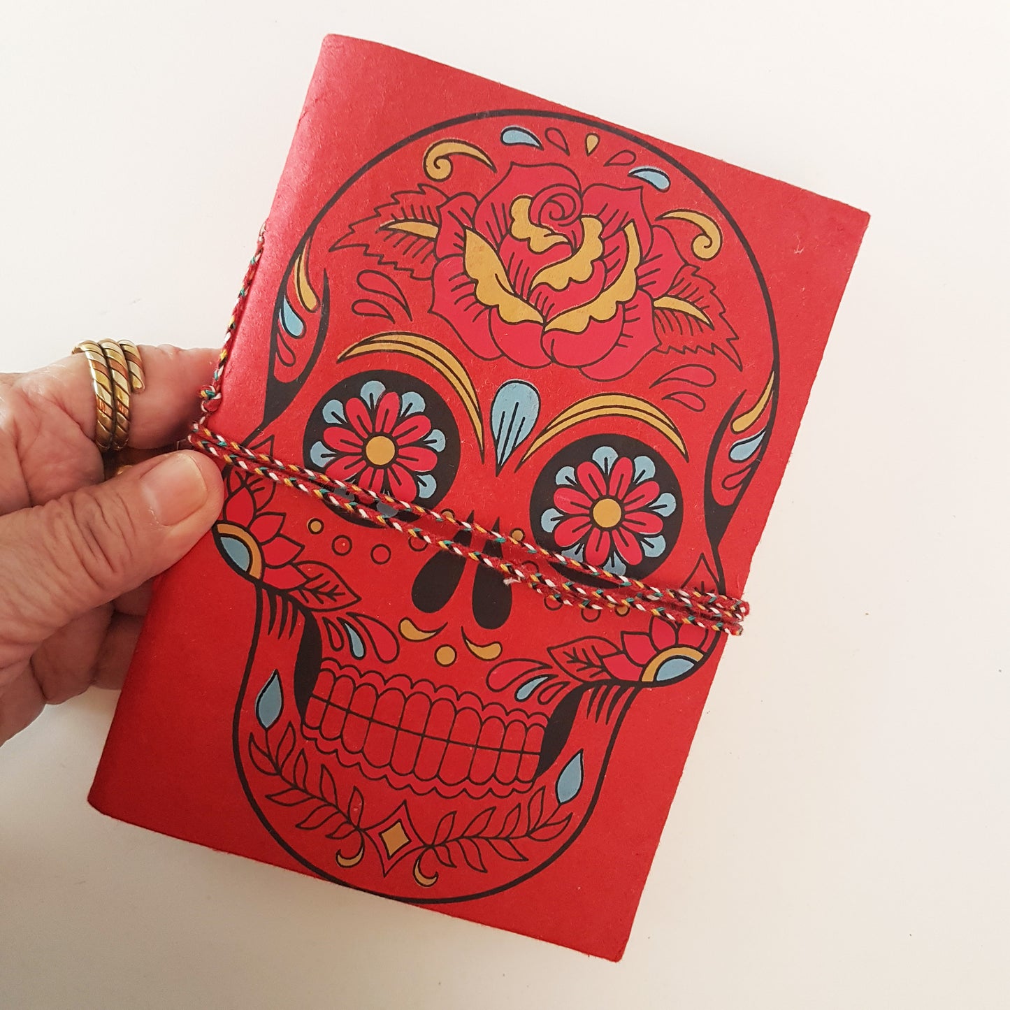 Red skull sketchbook jotter journal 5 by 7 inches with blank artisan paper pages. Colorful gothic day of the dead sugarskull design diary in red.