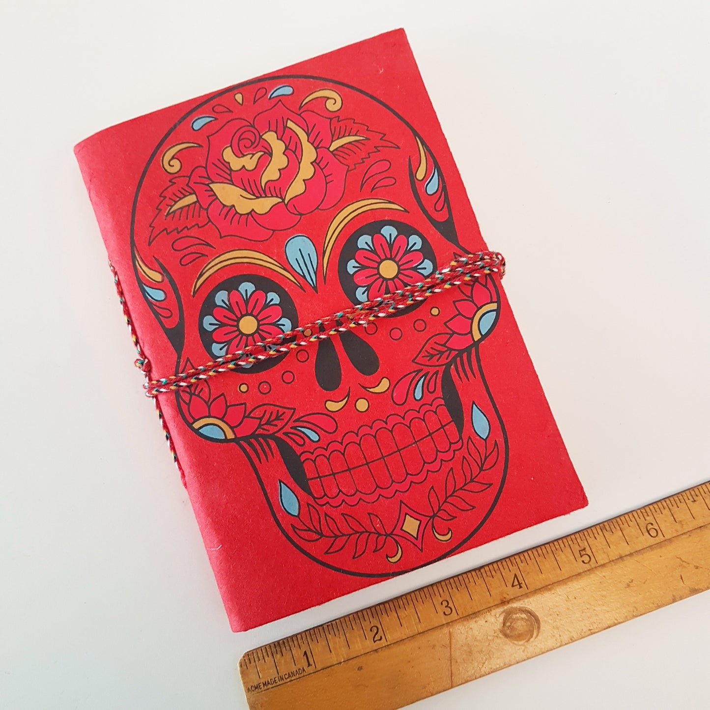 Red skull sketchbook jotter journal 5 by 7 inches with blank artisan paper pages. Colorful gothic day of the dead sugarskull design diary in red.