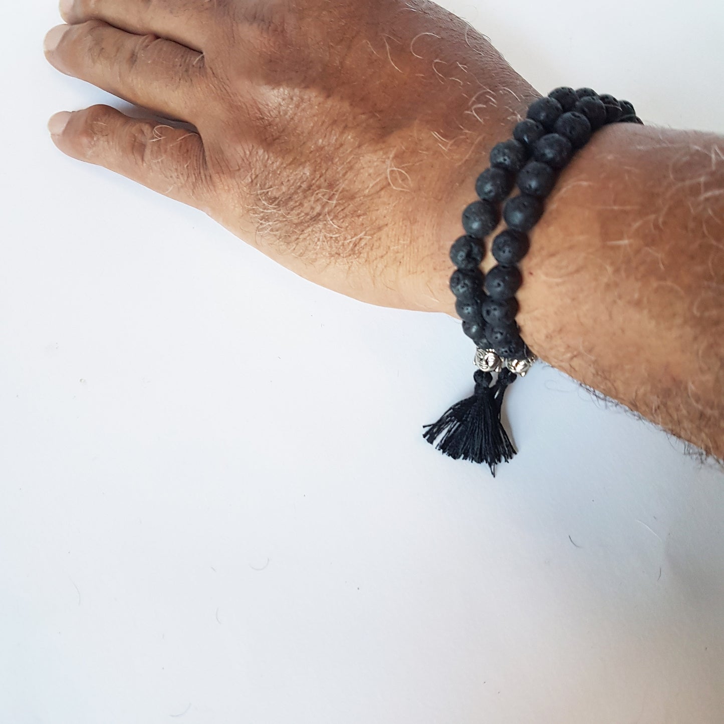 Natural black lava stone unisex meditation bracelet. Buddhist mala bracelet with silver buddha bead & black silk tassle. Yoga jewelry.