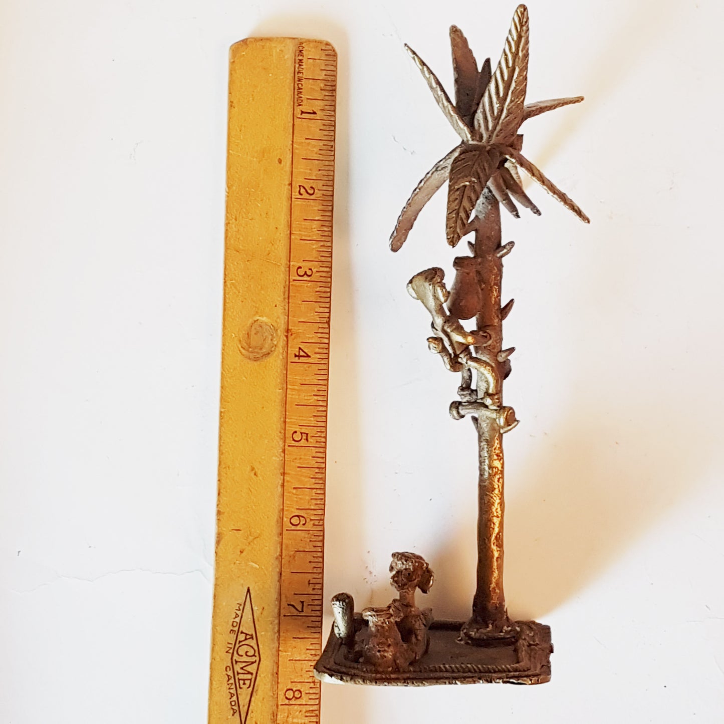 Vintage bronze monkey art sculpture. Monkey picking coconuts from tree. Animal metal collectable. India tribal art statue. 8 by 3 inches..