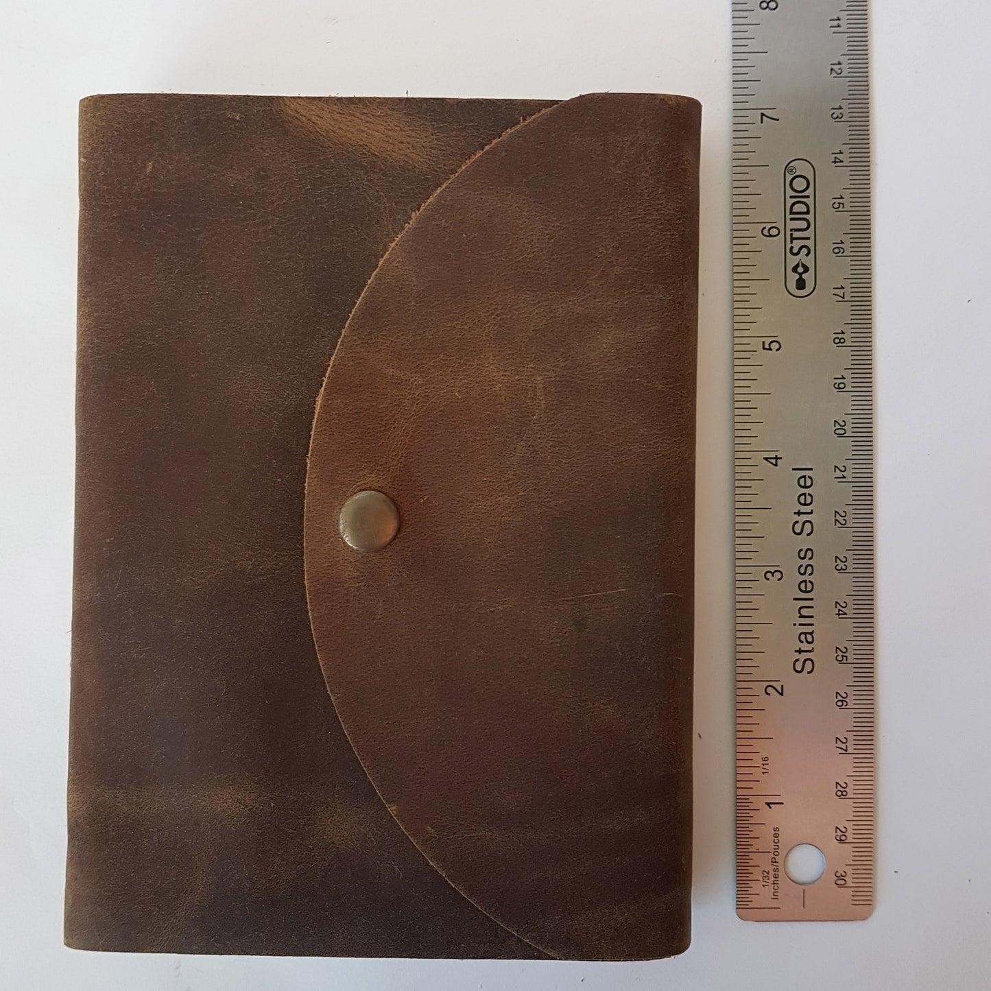 Leather bound brown suede journal with a rustic look. Pewter style button closure. Medieval design aesthetic.