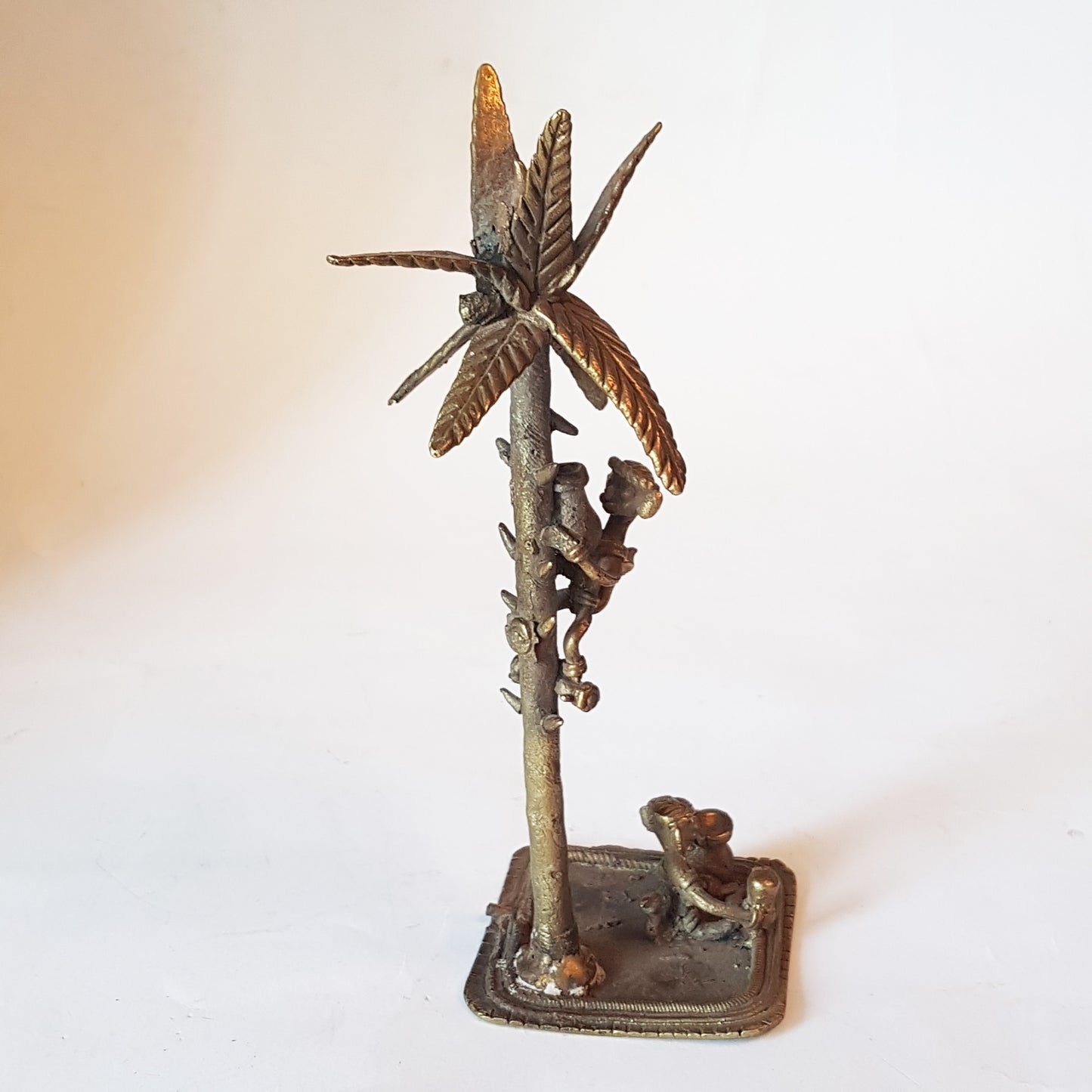 Vintage bronze monkey art sculpture. Monkey picking coconuts from tree. Animal metal collectable. India tribal art statue. 8 by 3 inches..
