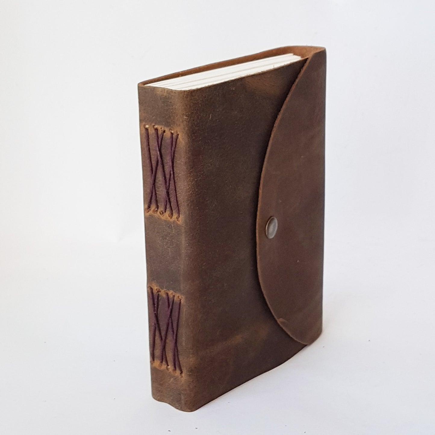 Leather bound brown suede journal with a rustic look. Pewter style button closure. Medieval design aesthetic.