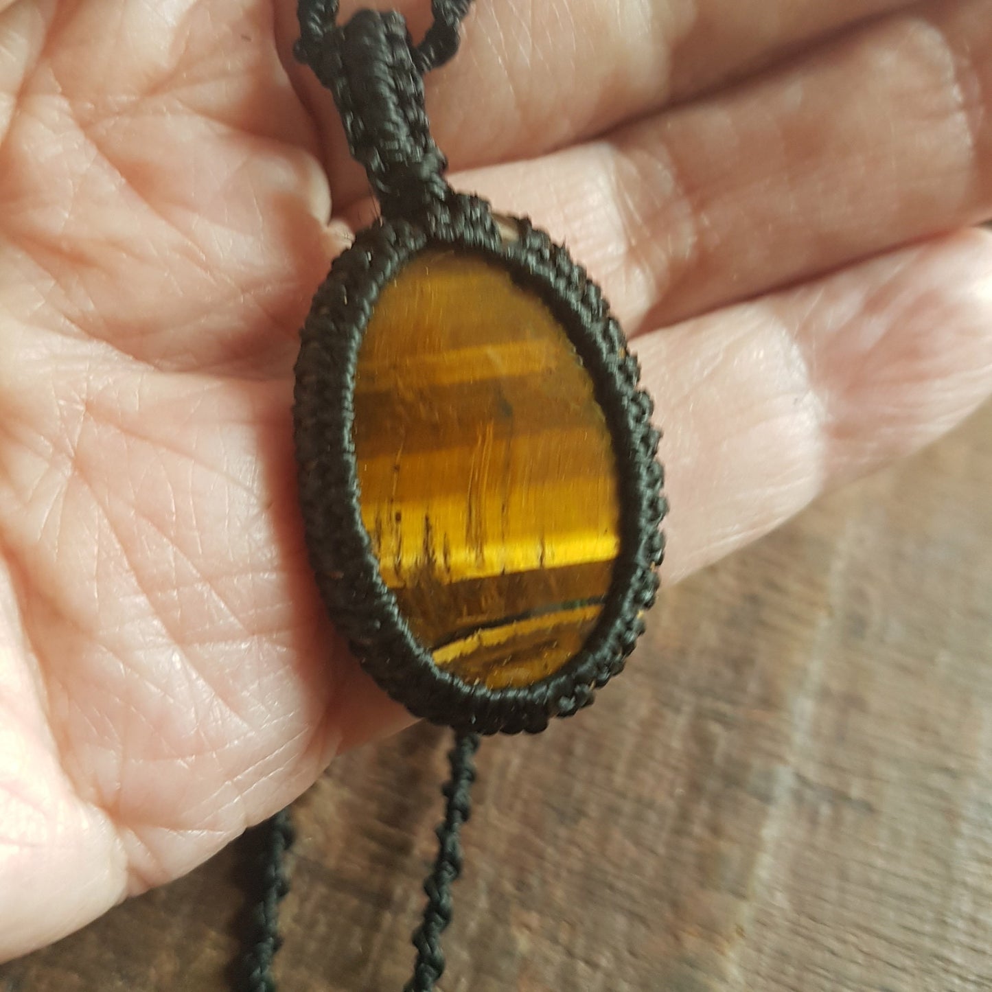 Gender neutral design tigereye pendant necklace. Hangs on a 20 inch black woven corkscrew knot cord. Adjustable length. Unisex jewelry. - Vintage India Ca